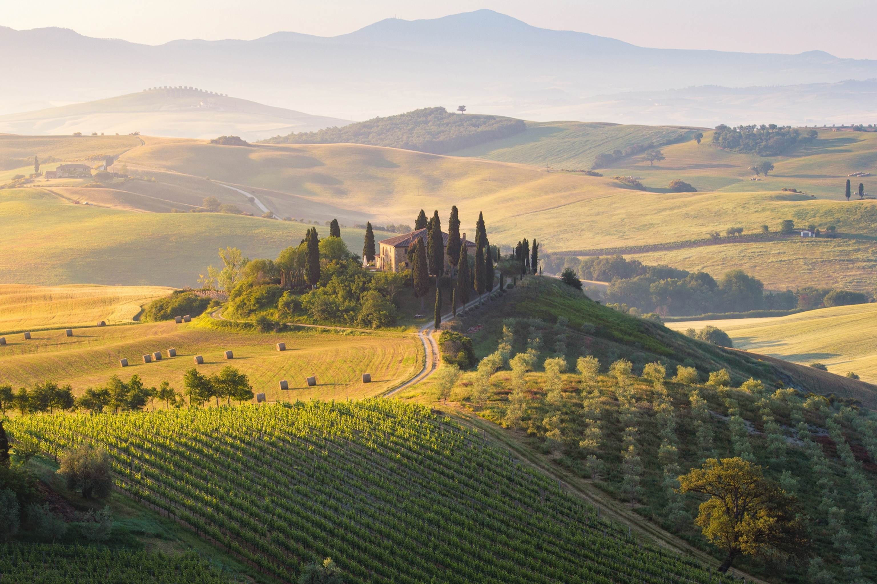 Rolling farmland in Tuscany with a fortified hilltop settlement.