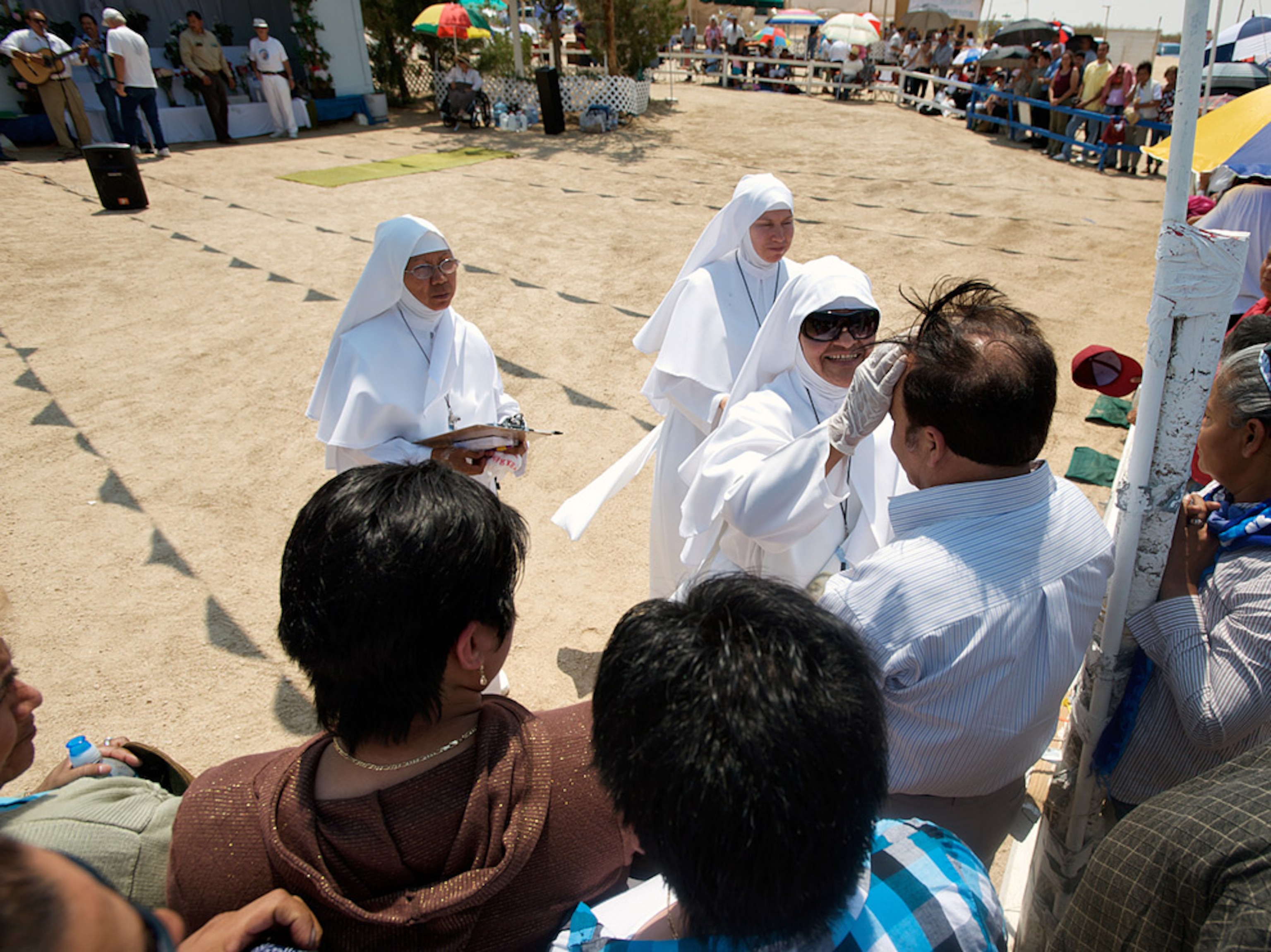 A woman touching a man’s forehead