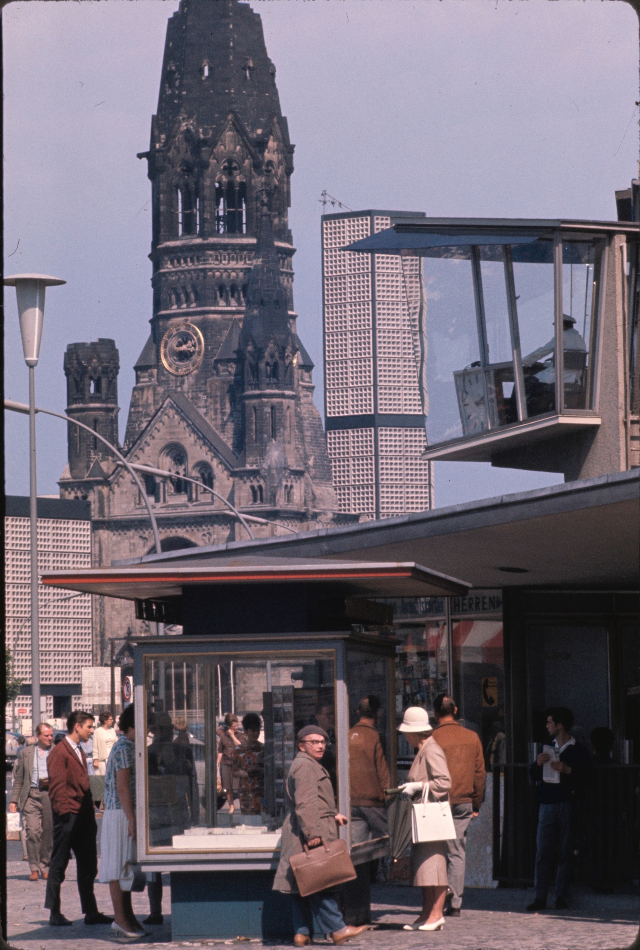 Bombed spire of Kaiser Wilhem Memorial Church, the "broken tooth" as some Berliners call it, stands as a grim reminder of war's desolation. Honeycomb chapel and campanile, both new, flank the gutted tower.