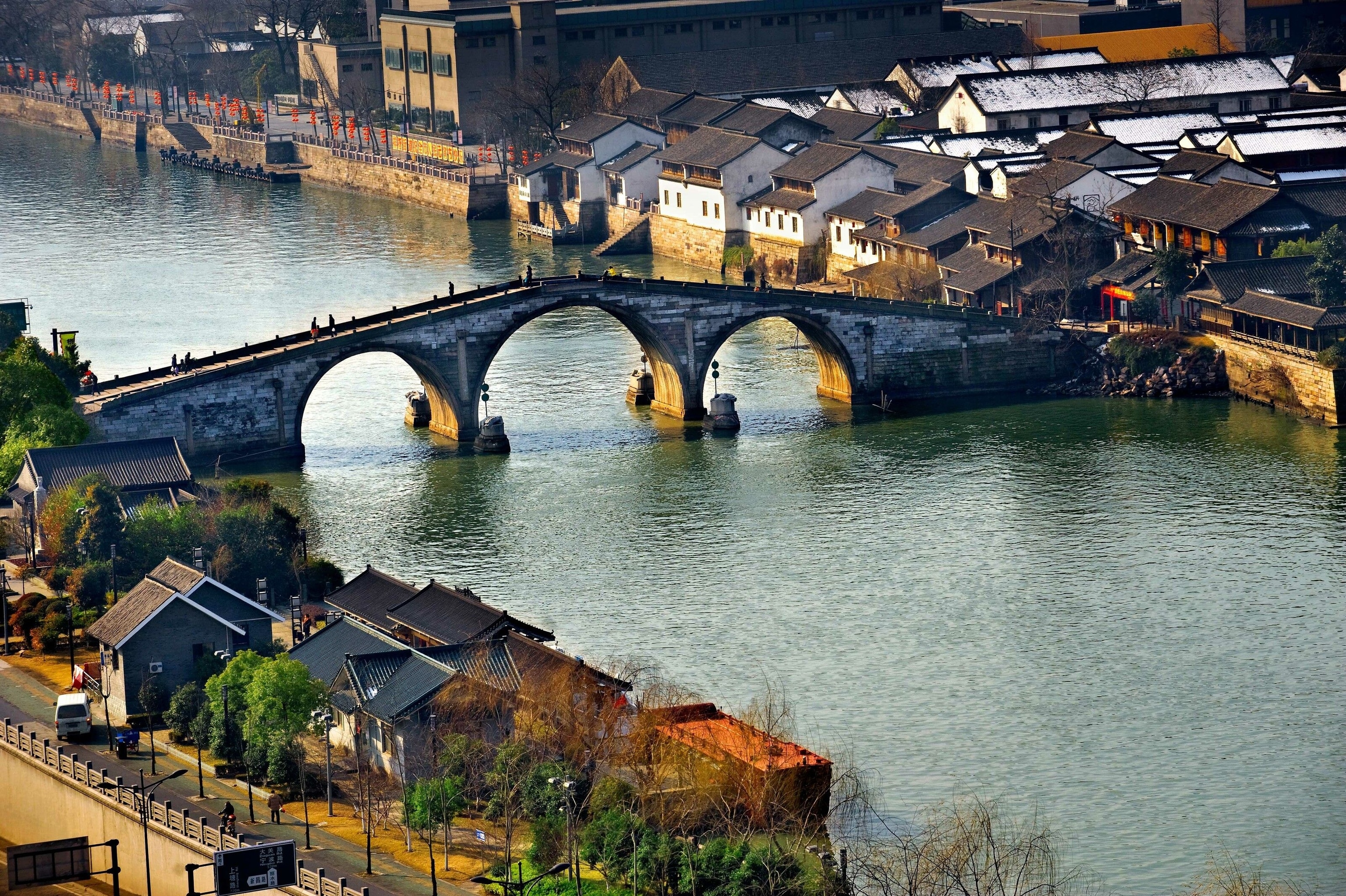 A bridge over the Grand Canal. It is stone and has three arches, the largest of which is the central arch.