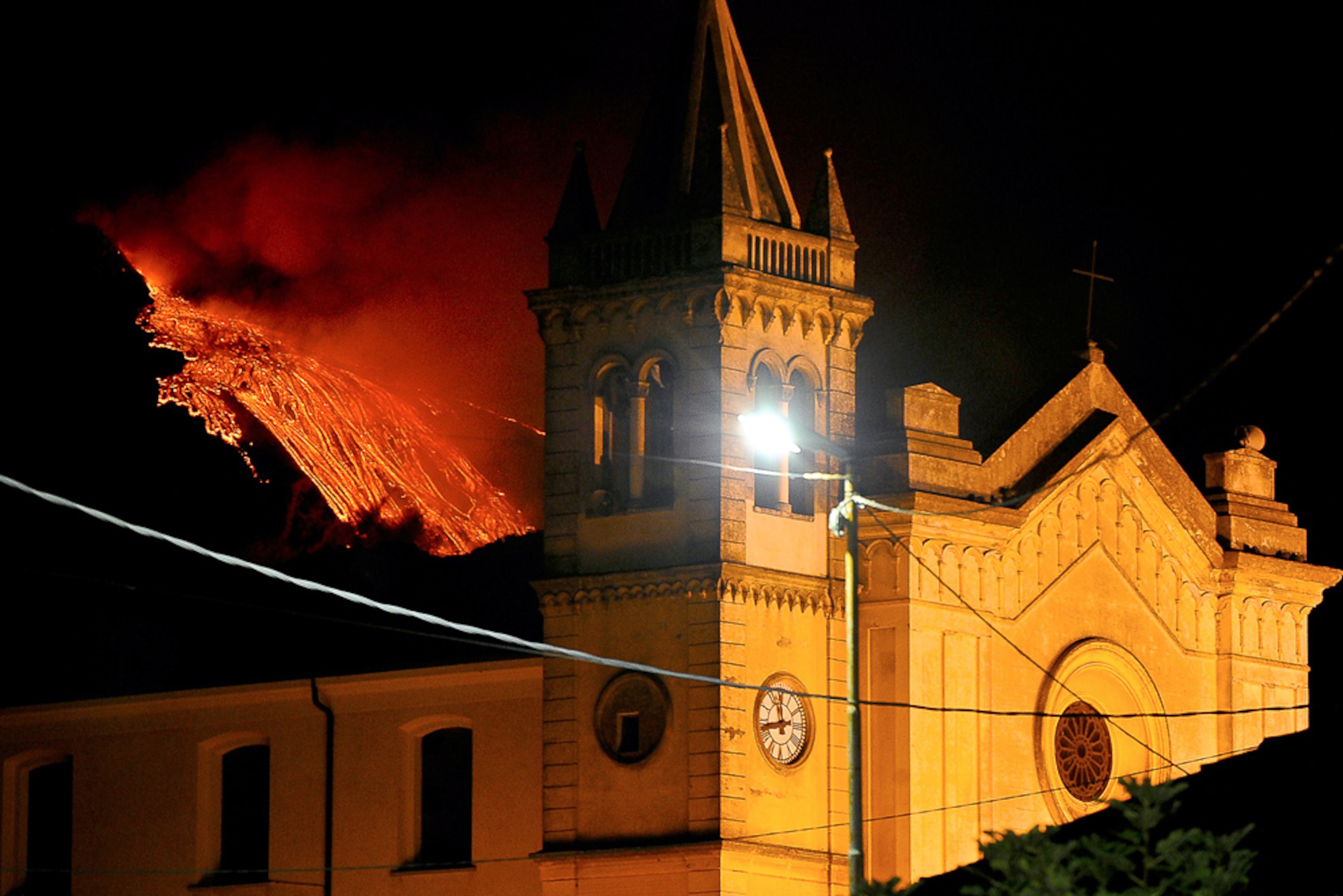 Mount Etna picture: Italy volcano eruption behind church on July 30