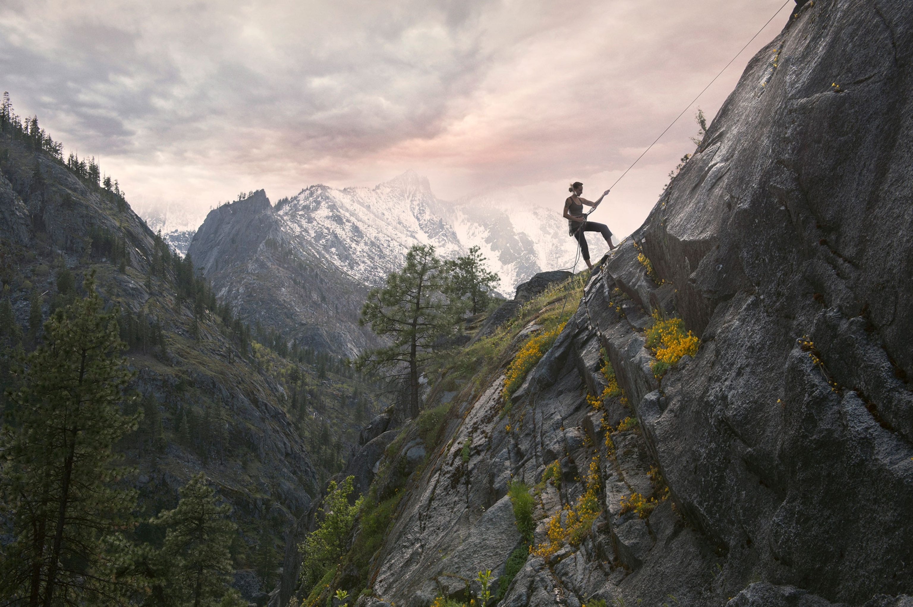 a climber rappelling down a rock in Washington