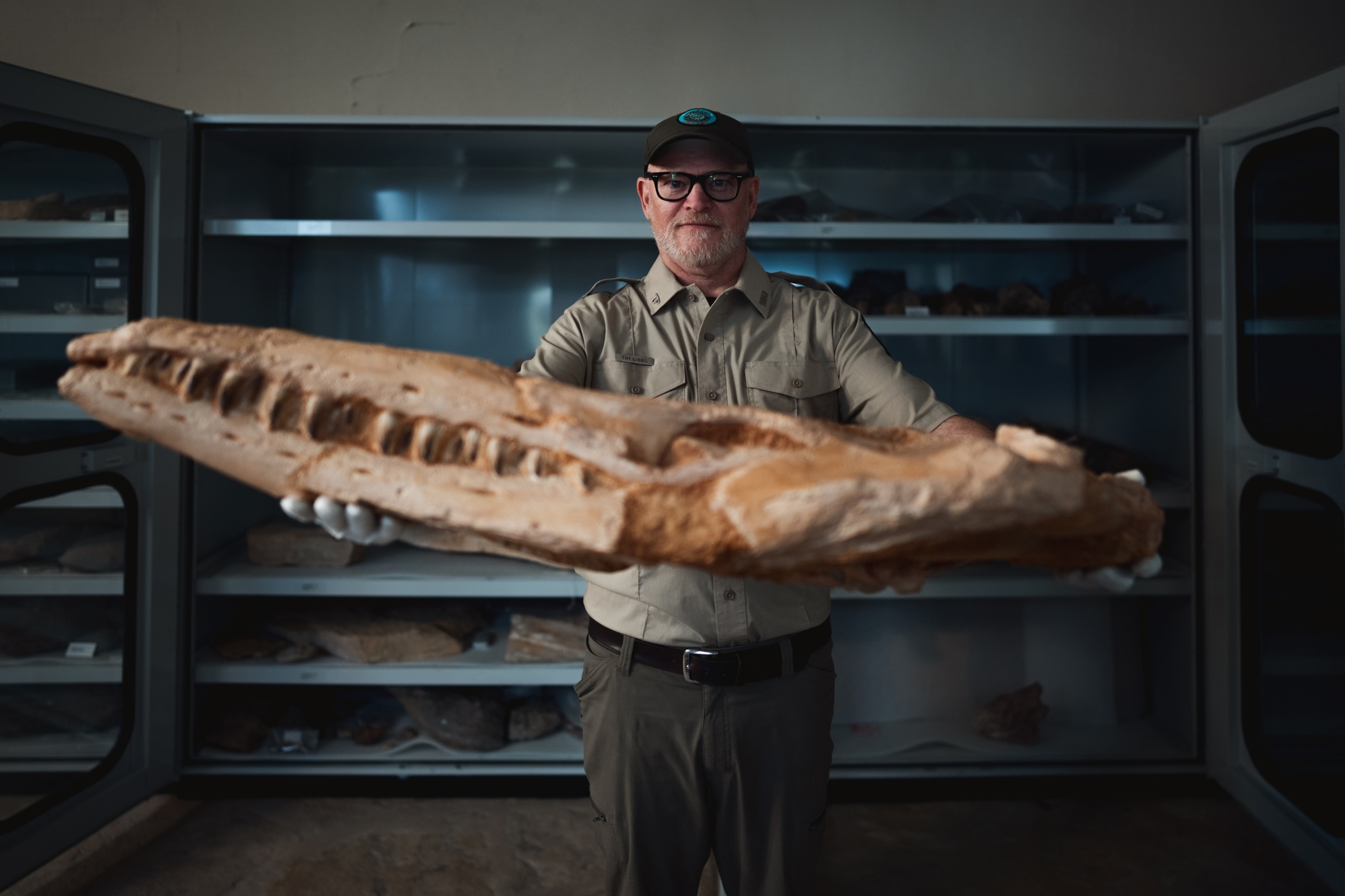 Archaeologist Tm Gibbs displays a mosasaur fossil at Big Bend Ranch State Park.