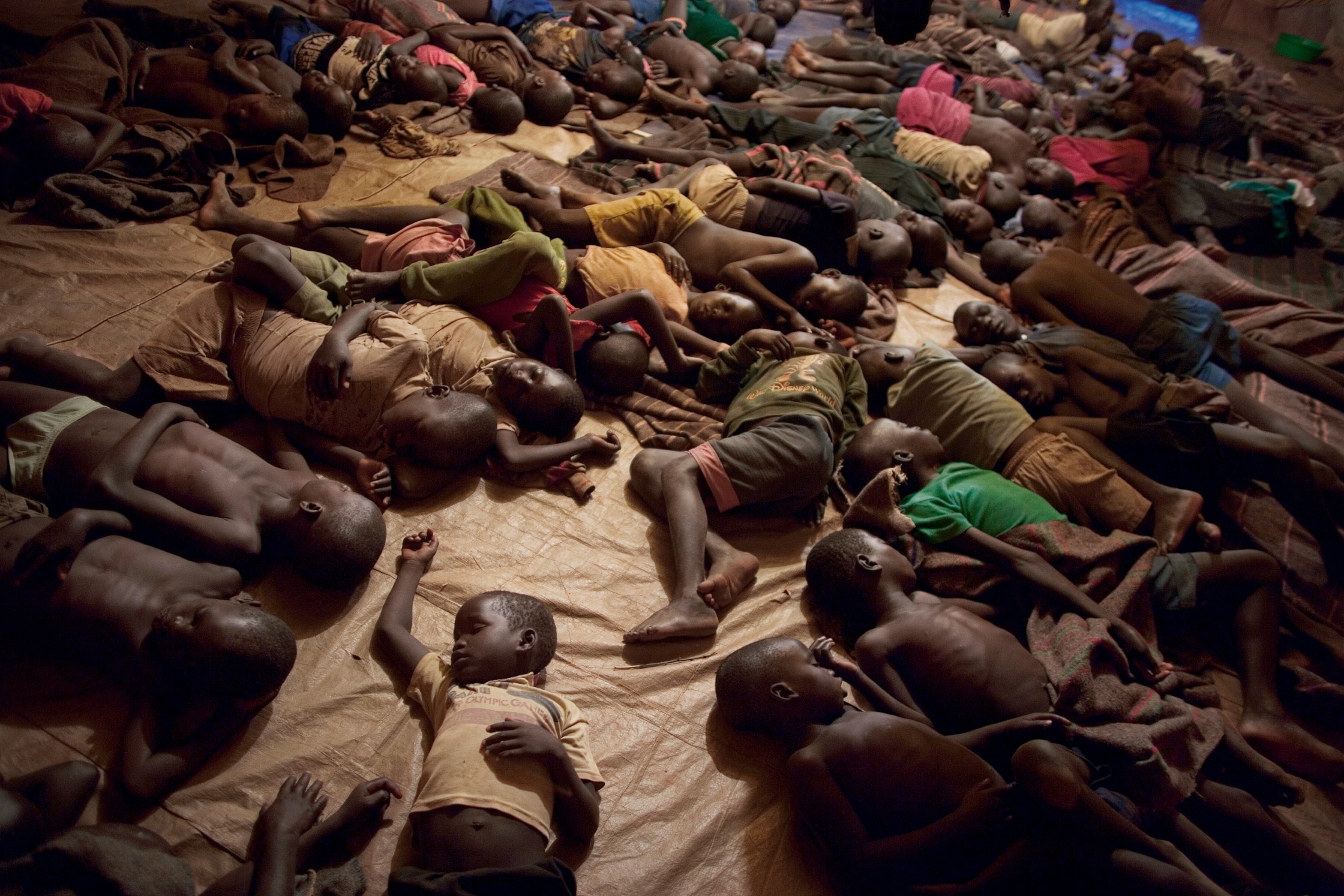 children sleeping on floor in uganda