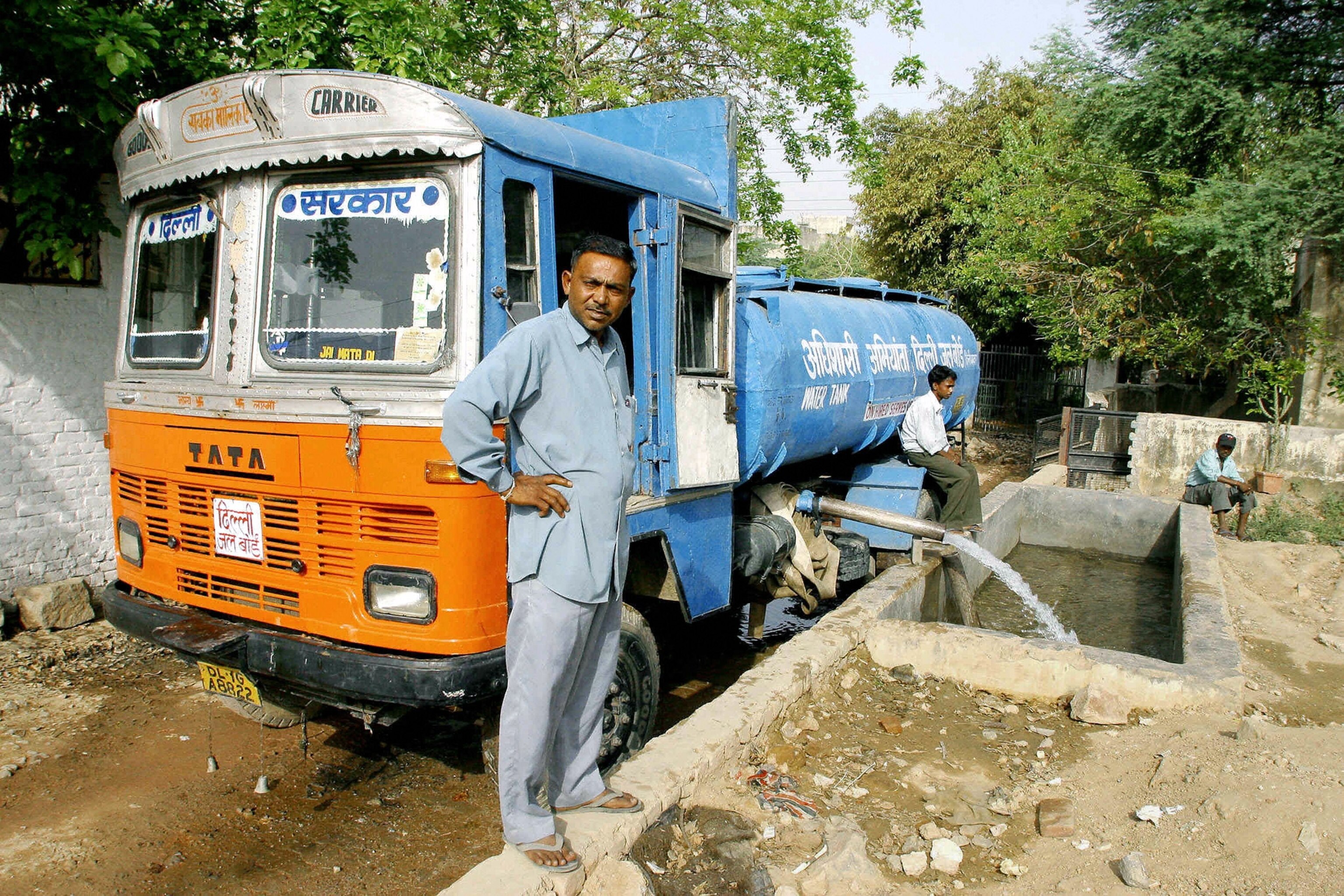 A tanker fills a water reservoir in New Delhi, India.