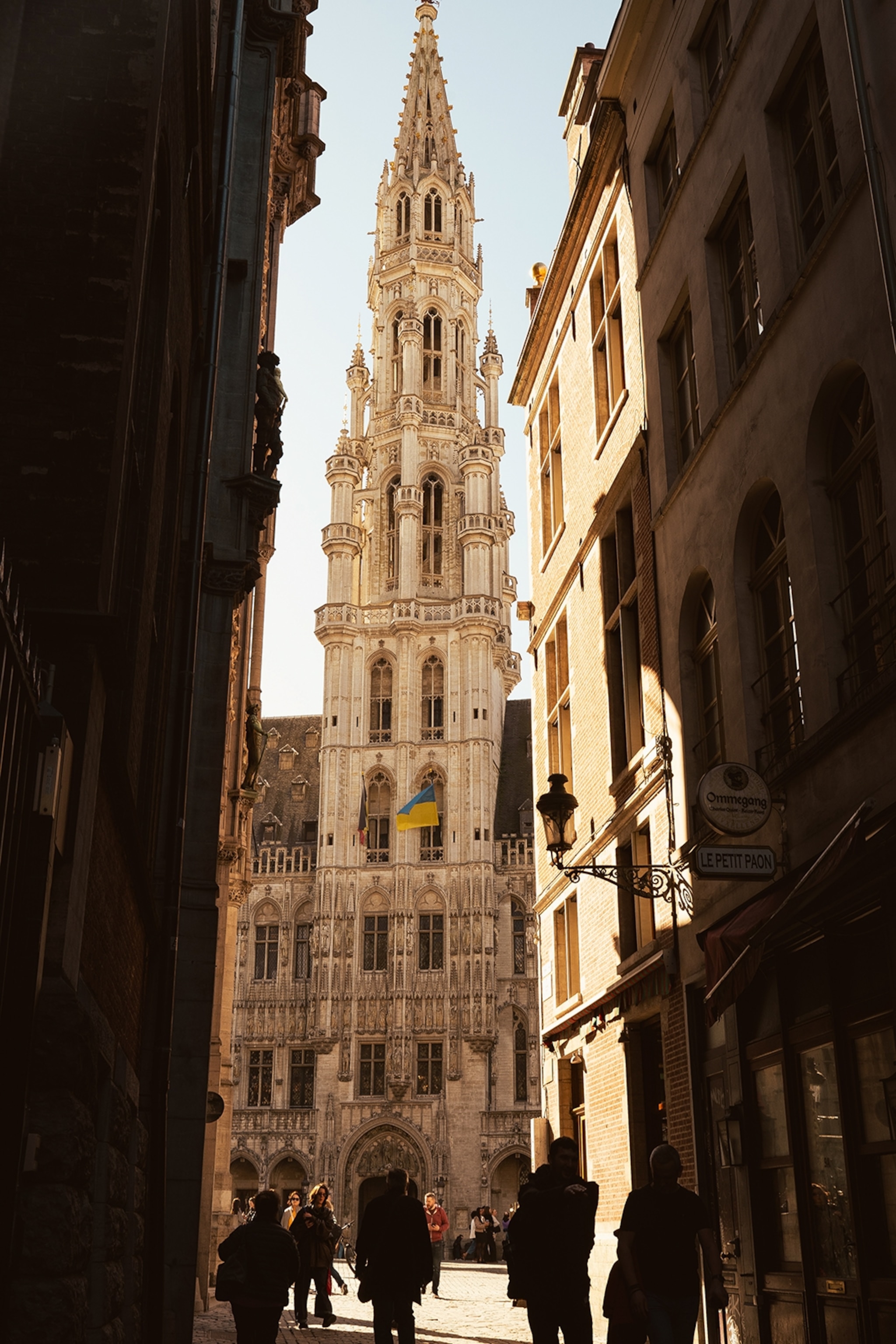 Street view of a clocktower on a sunny day.
