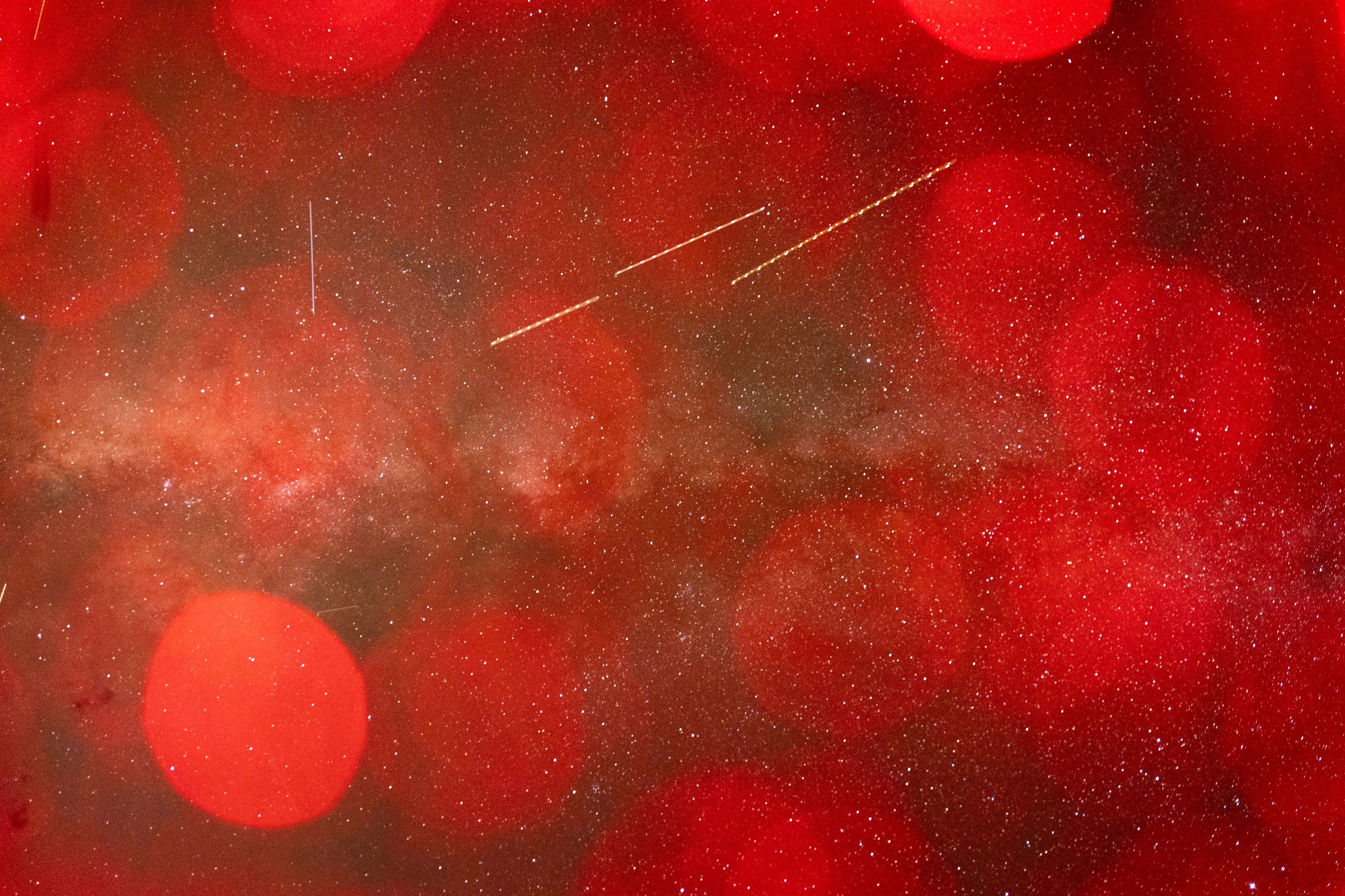 Long exposure of the night sky at Mars Desert Research Station outside of Hanksville, Utah on October 22, 2025. Our entire crew remarked that we had never seen the stars as clearly as we did at MDRS. The Milky Way stretched a full 180 degrees across the sky. I added a red flash gel to create the bokeh effect and allude to us being on Mars (while still on Earth).