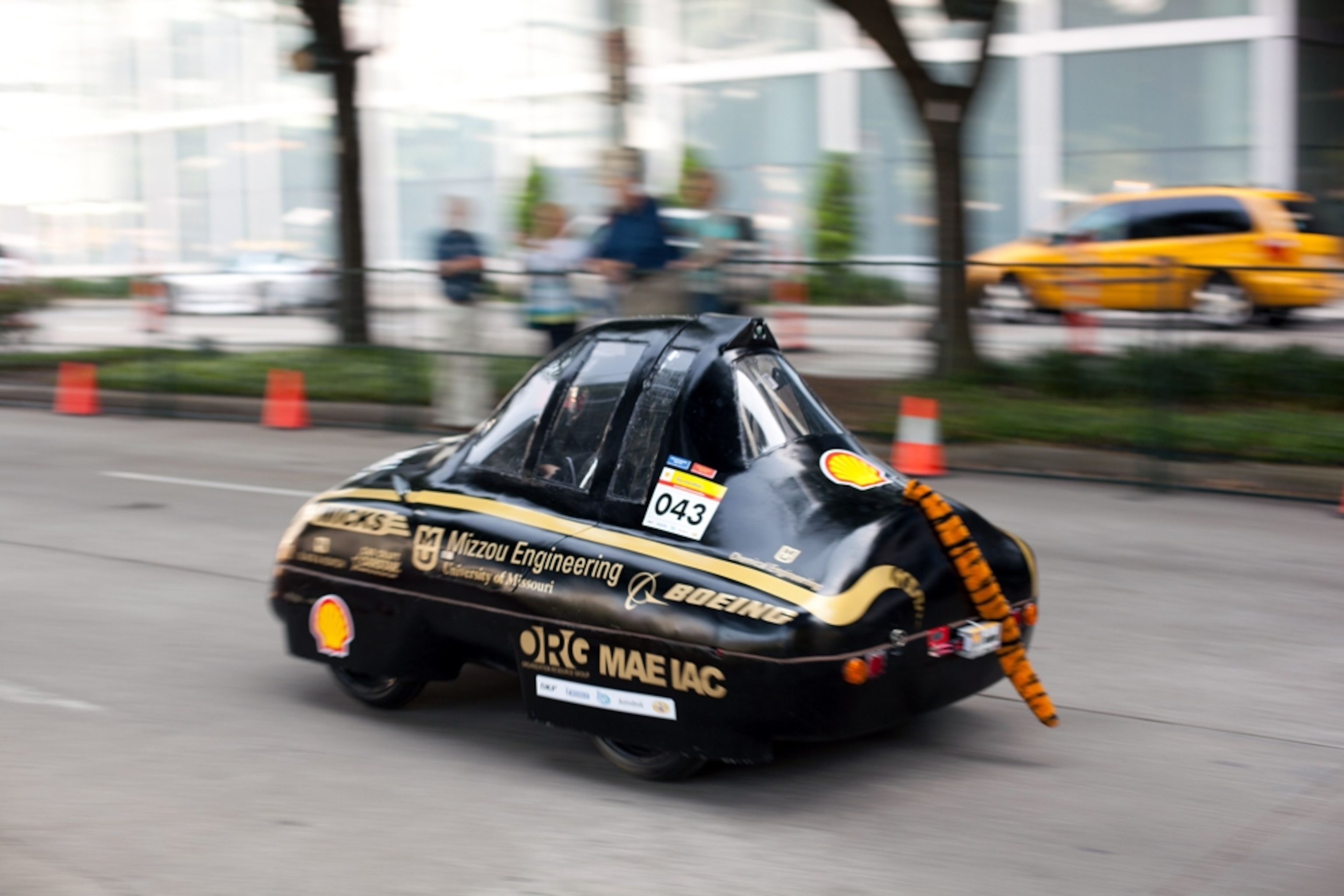Tiny black car with a tiger tail