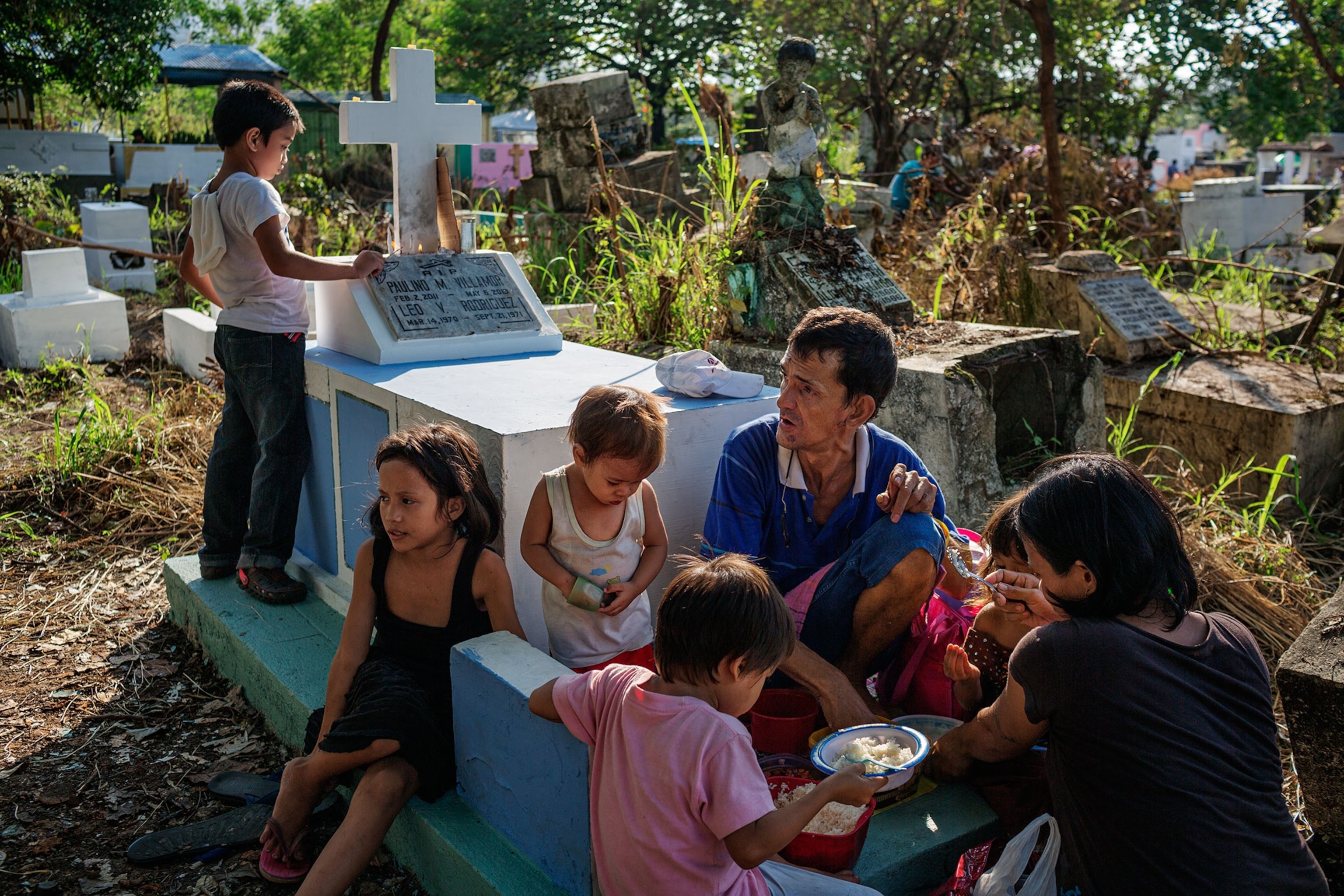 a family at a grave