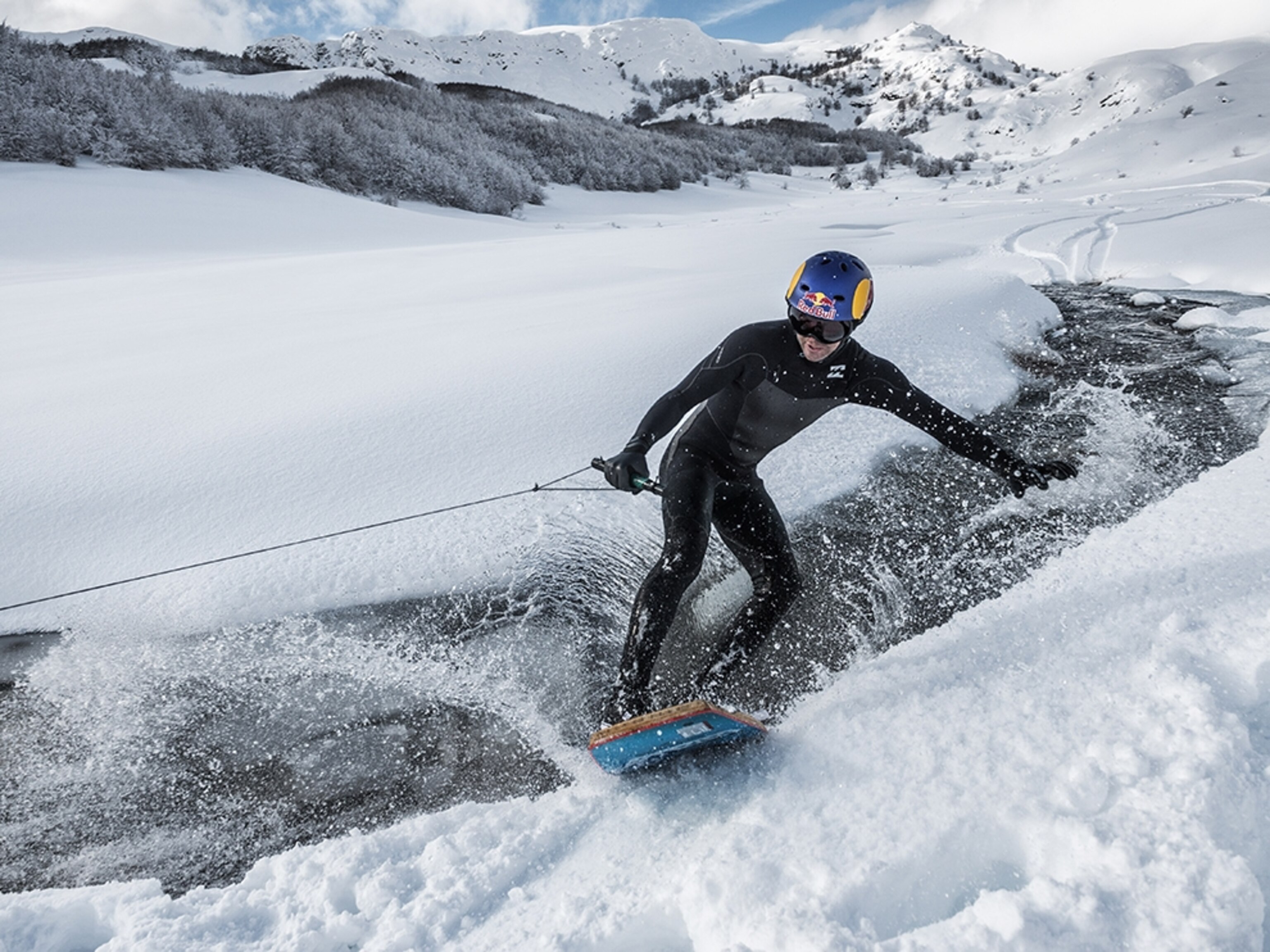 a wakeskater in a snowy creek