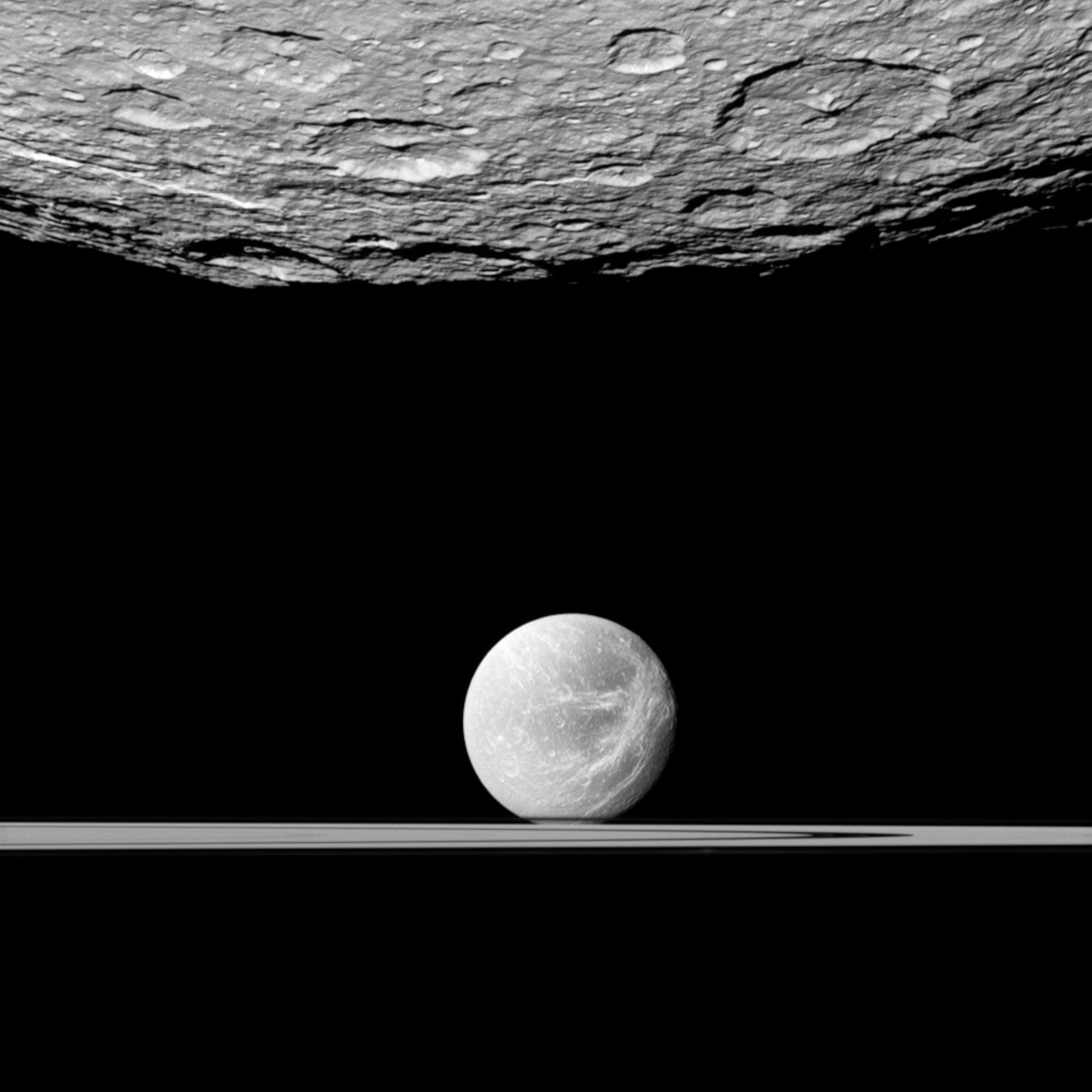 Saturn's moons Dione and Rhea with the planet's rings
