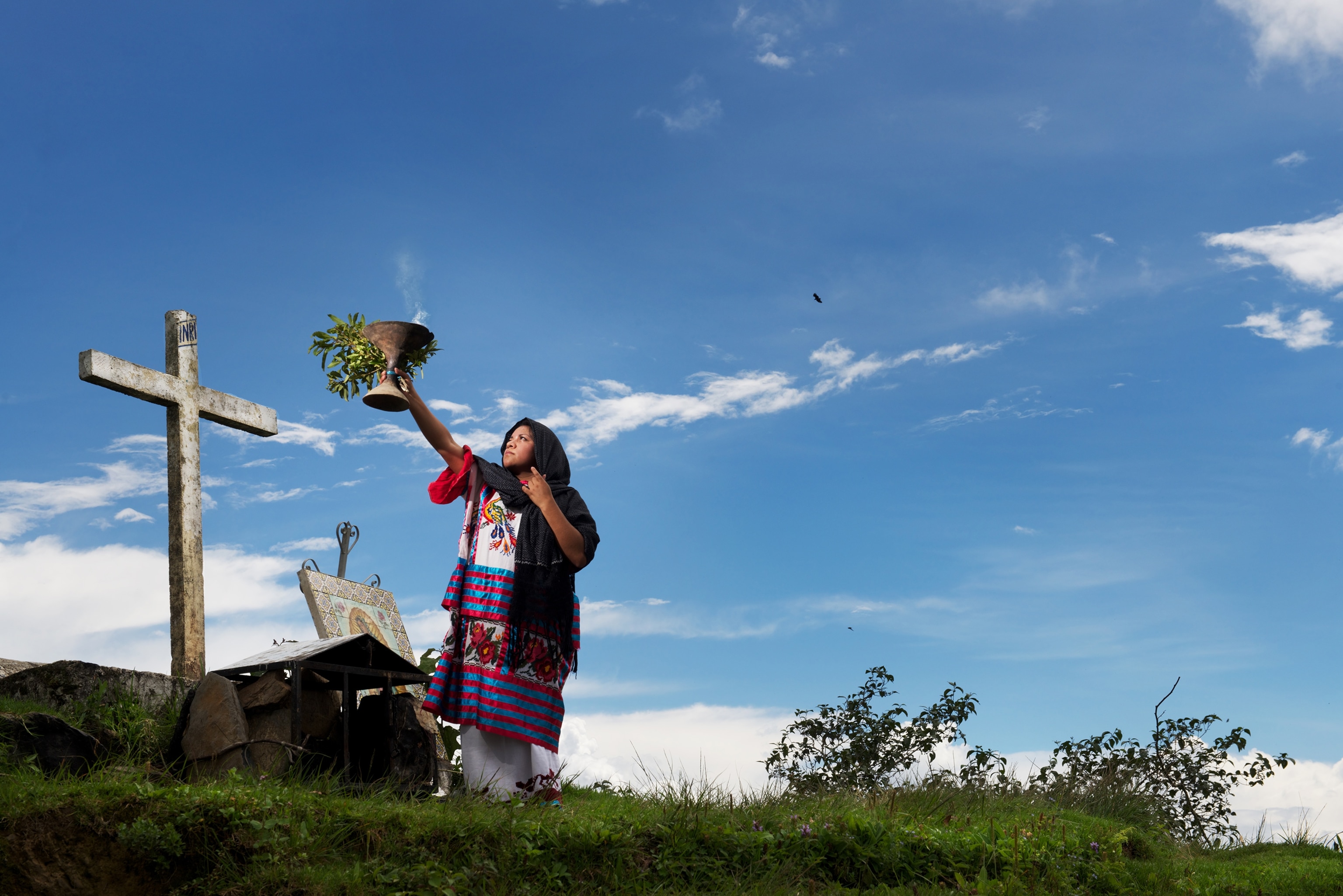 a Mazatec woman making an offering in Oaxaca, Mexico