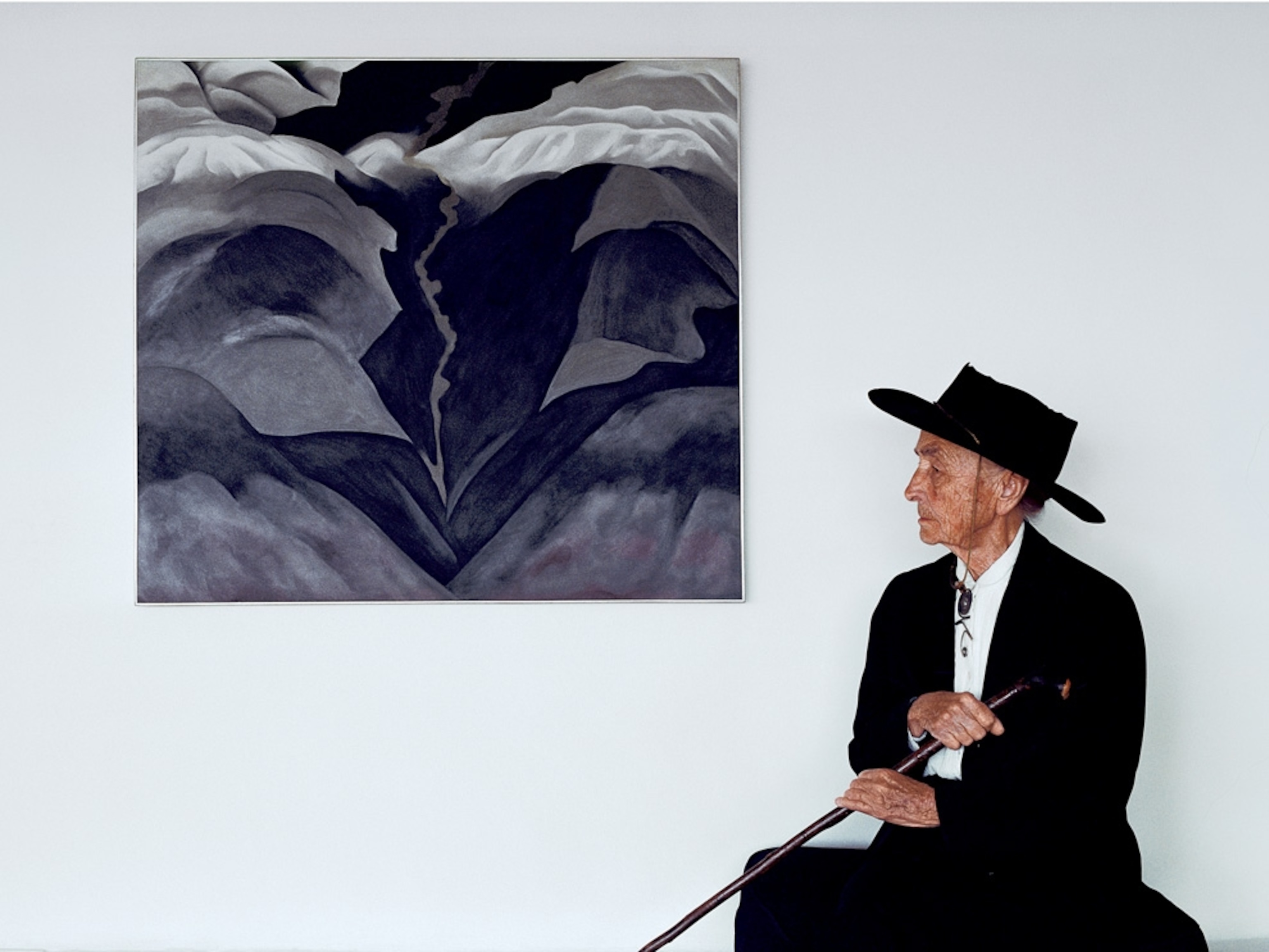 Artist sitting next to a painting