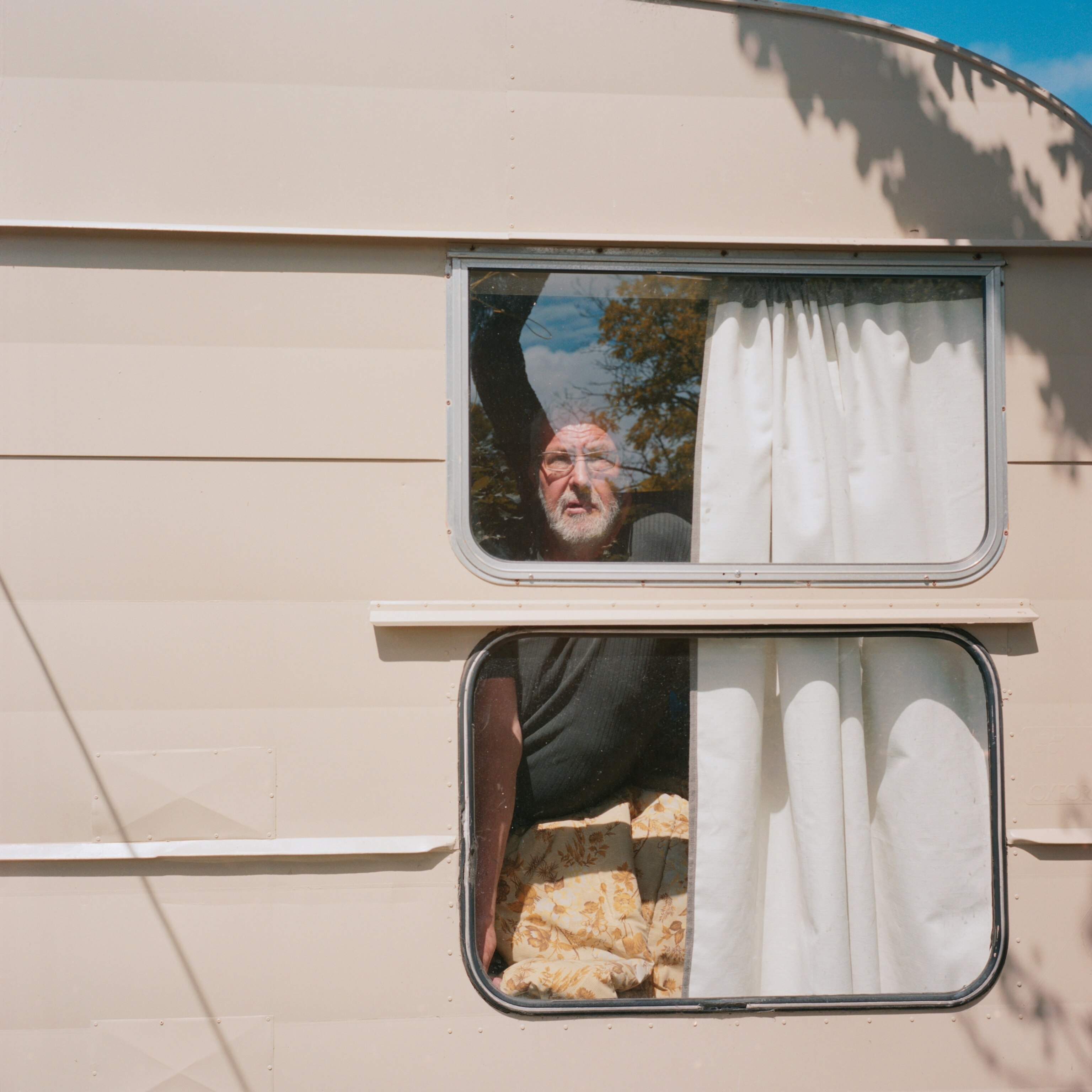 man looking out RV window