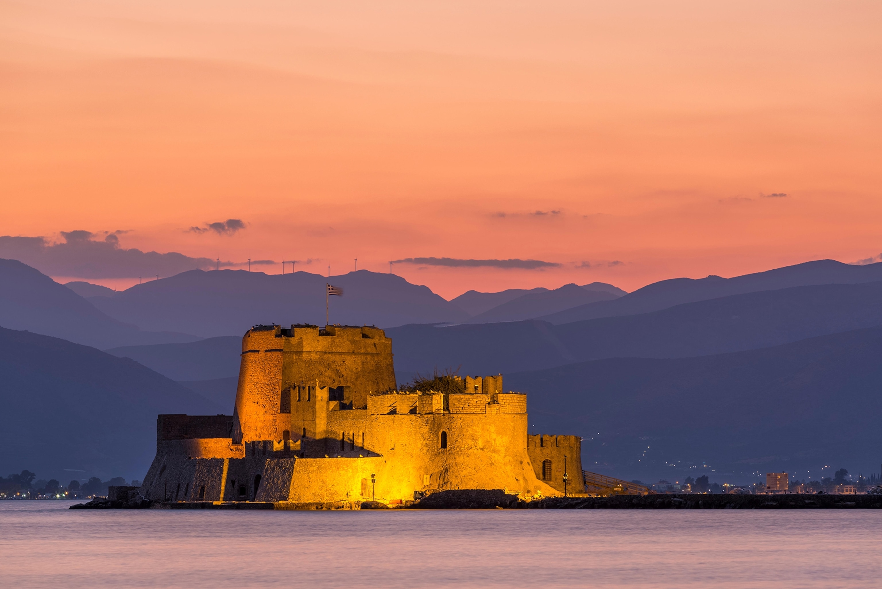 Evening view of Bourtzi fortress with mountains in the background in Nafplio