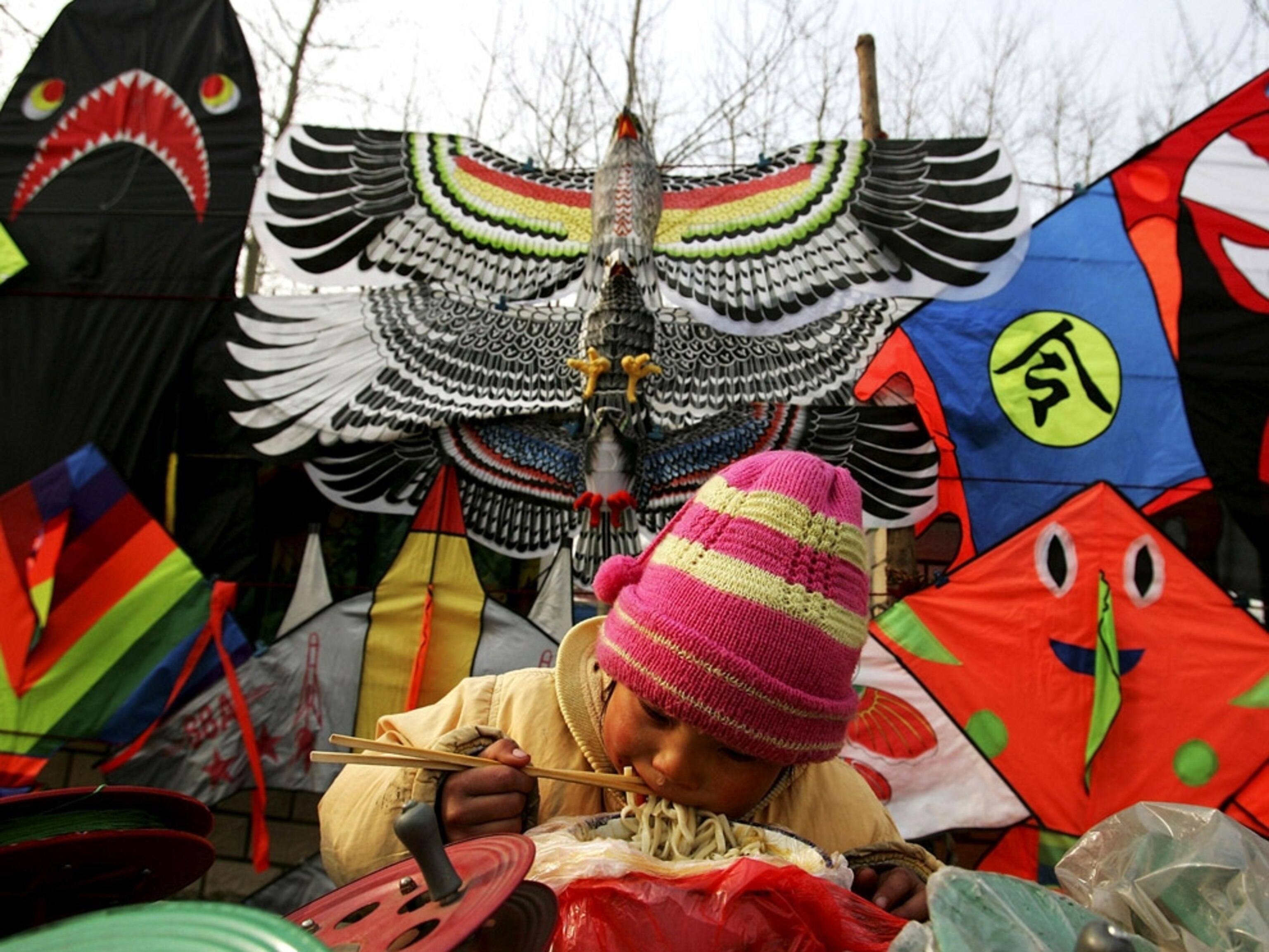 Young girl at kite stand