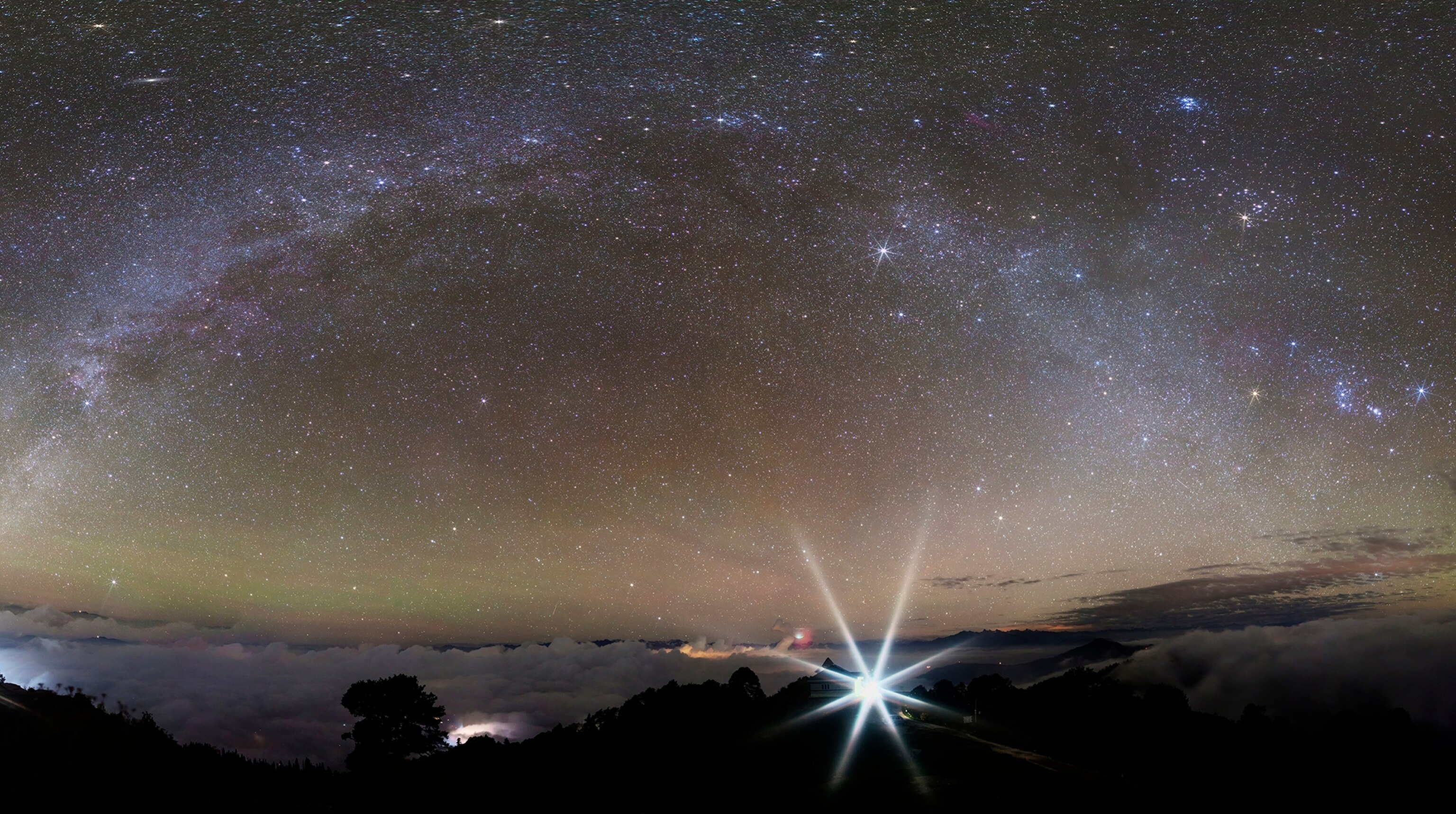 From an 11000 foot peak near the town of Narkanda in the Northern India province of Himachal Pradesh, the sky constellation Cygnus is on the left along the Summer Milky Way.