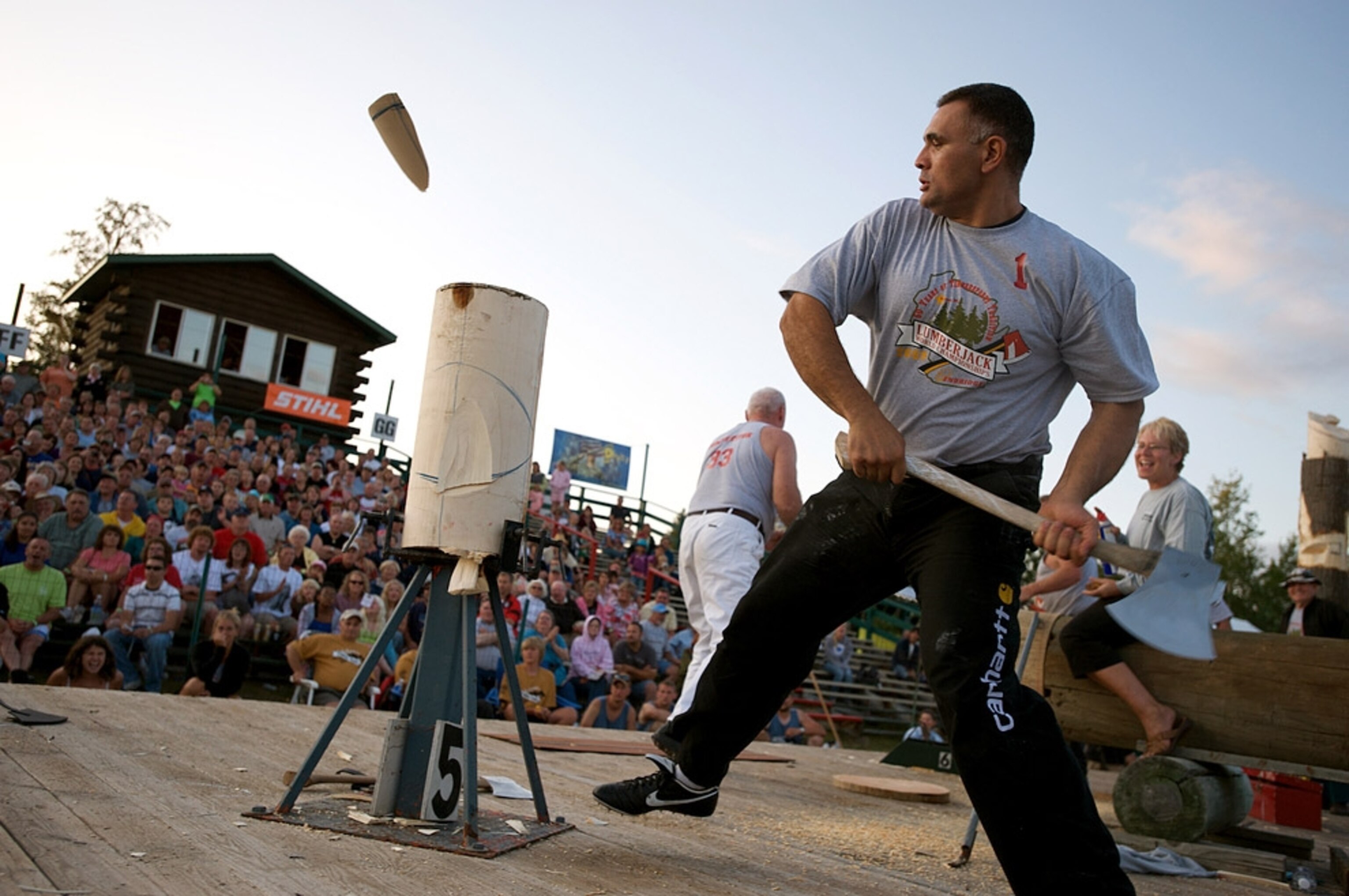 Lumberjack competing before crowd