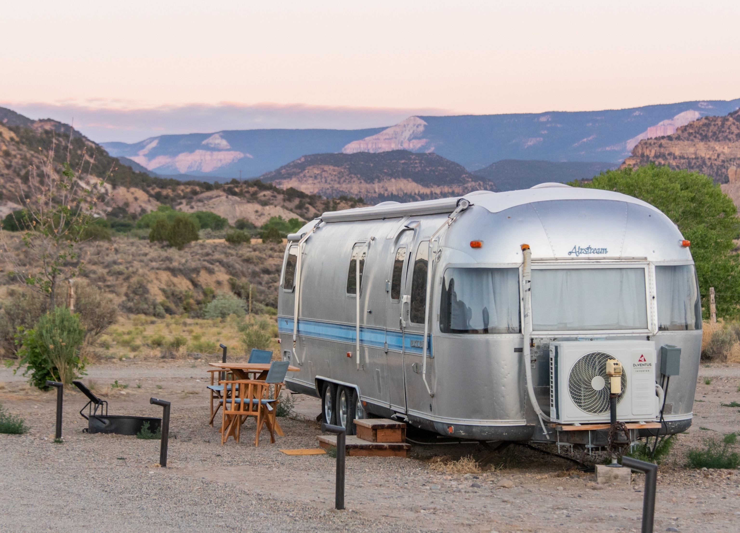 an airstream camper in the dessert at dusk