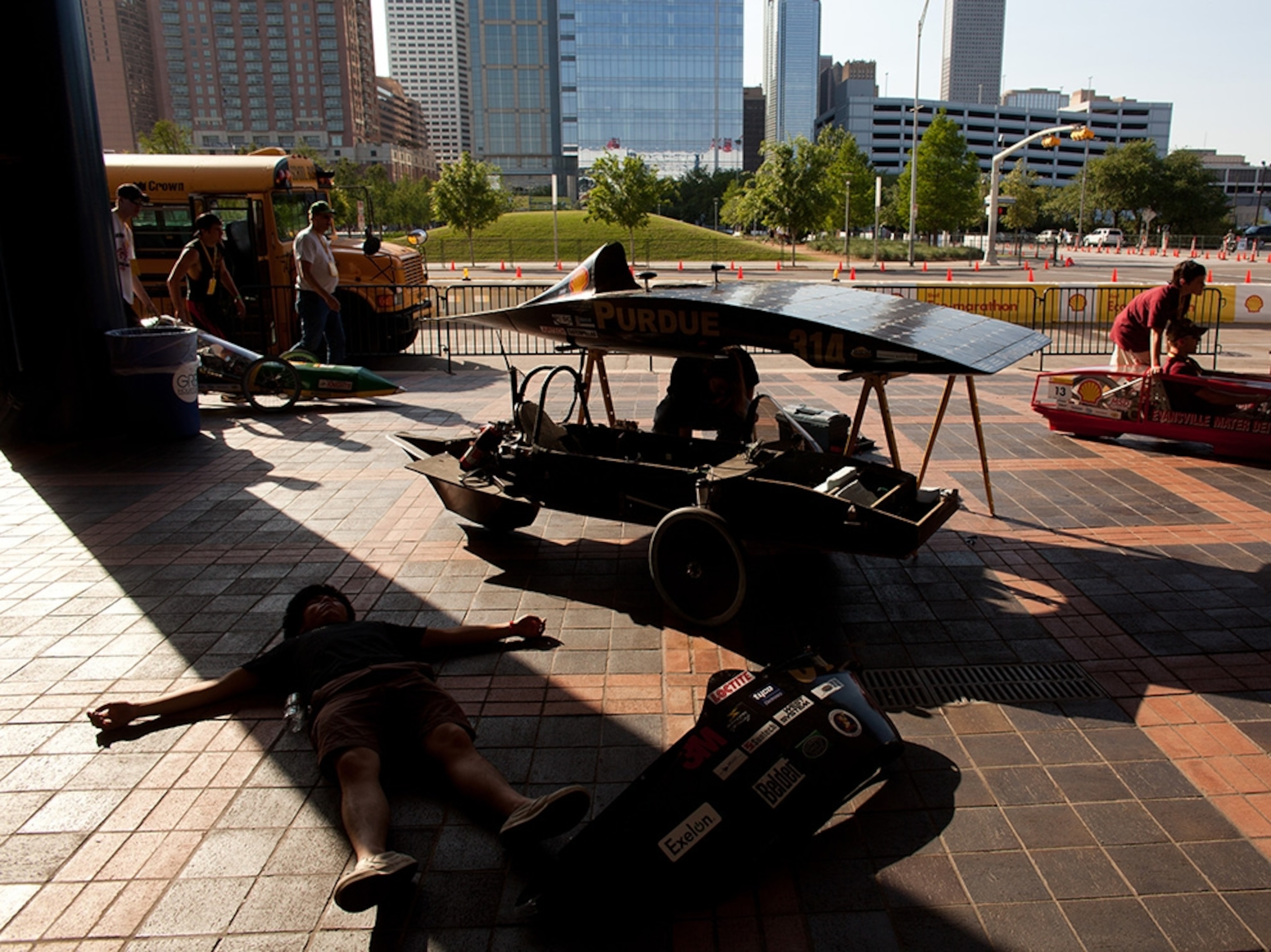 Although his team’s solar car needs the sun to run, Purdue University team member Kevin Wang seeks the shade for some rest after an afternoon of making adjustments to the team’s prototype-style vehicle.