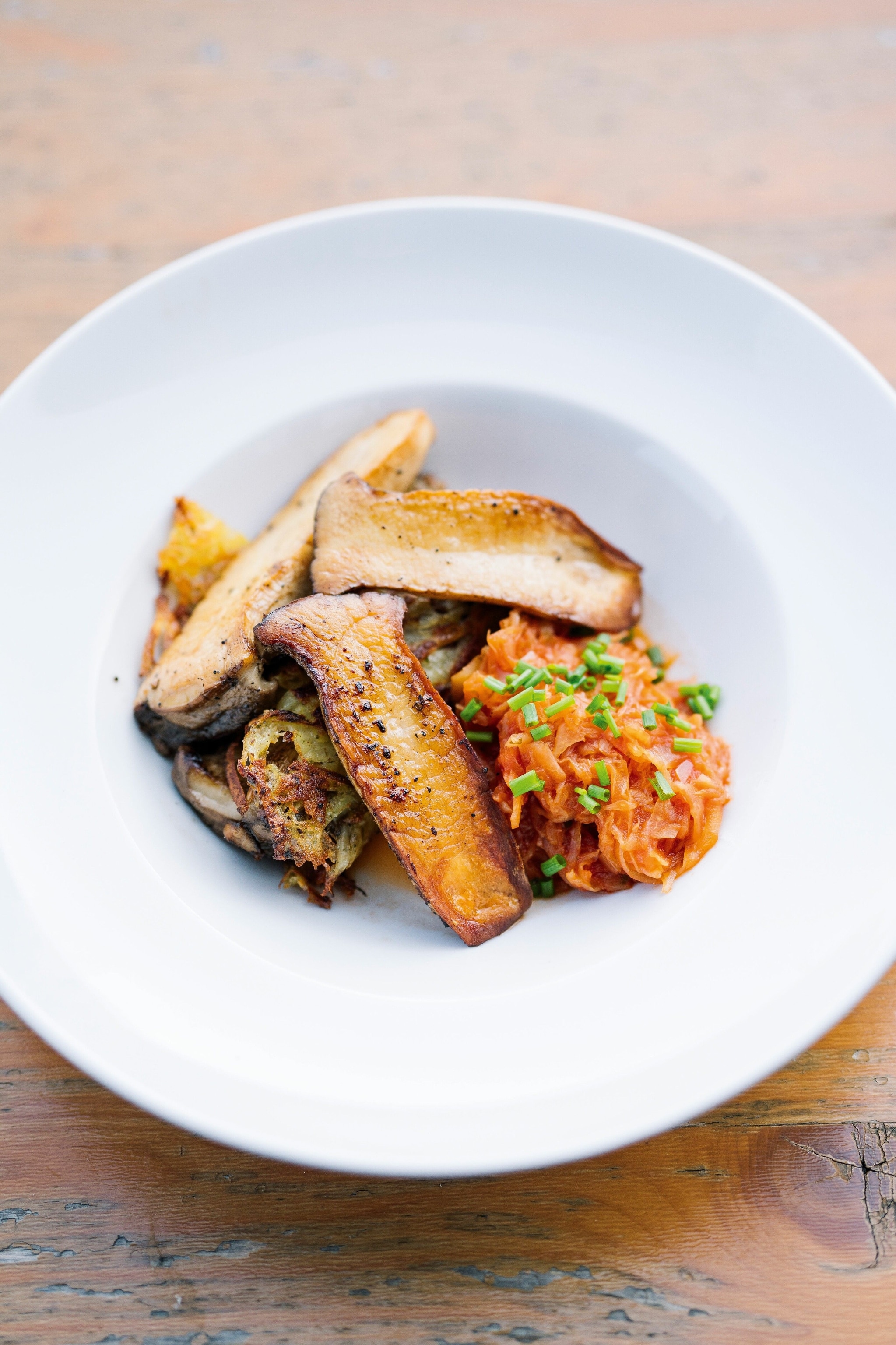 Forest mushrooms with potato rösti, paprika-spiced sauerkraut and chive sauce