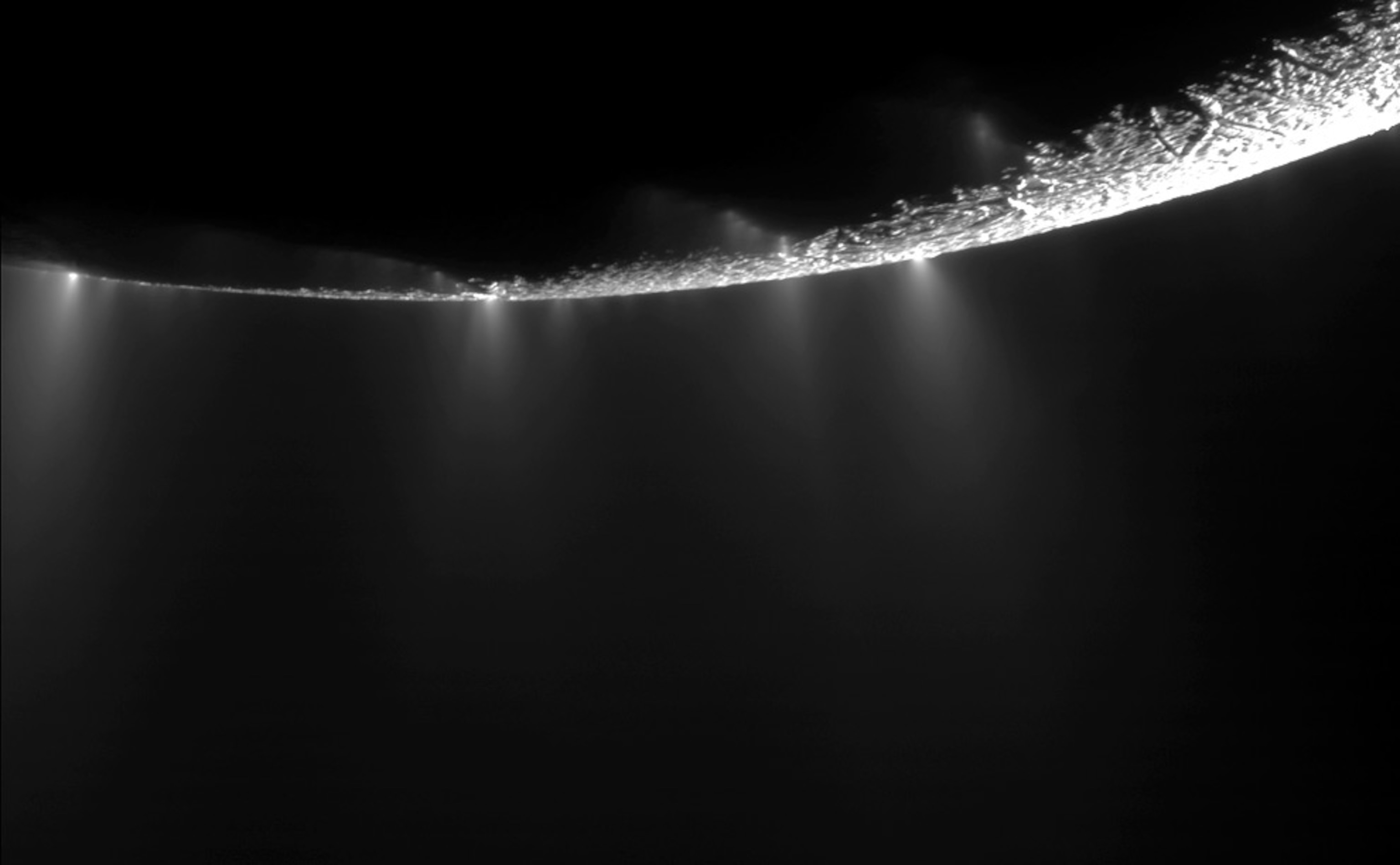 Plumes appear as bright spots along the apparent edge of Saturn's moon Enceladus in a new picture