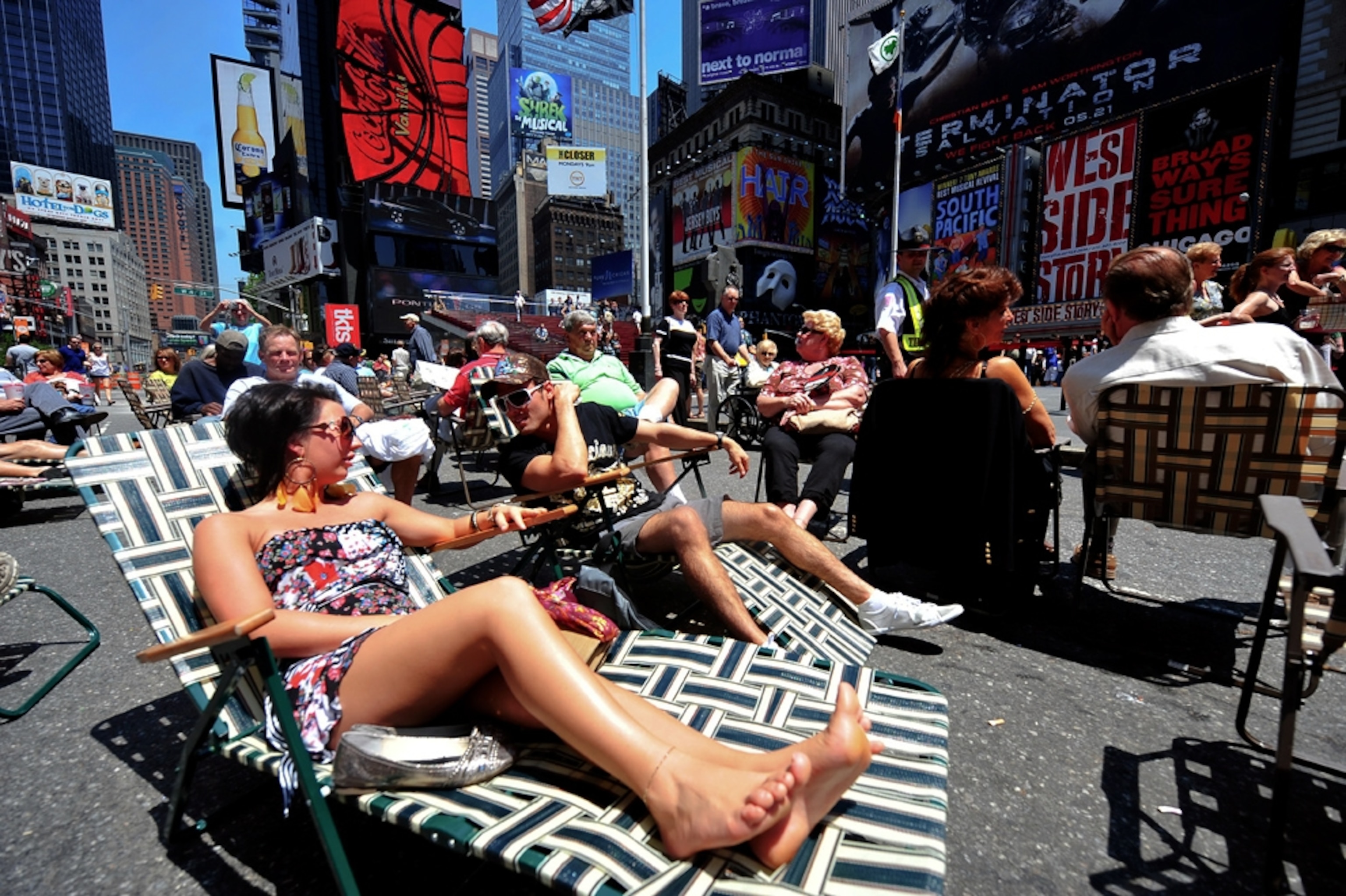 Visitors on beach chairs in New York’s Times Square