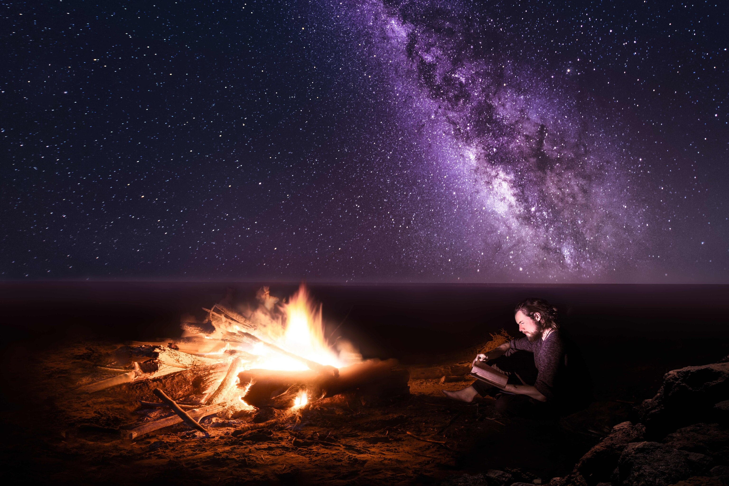 a campfire on the beach.