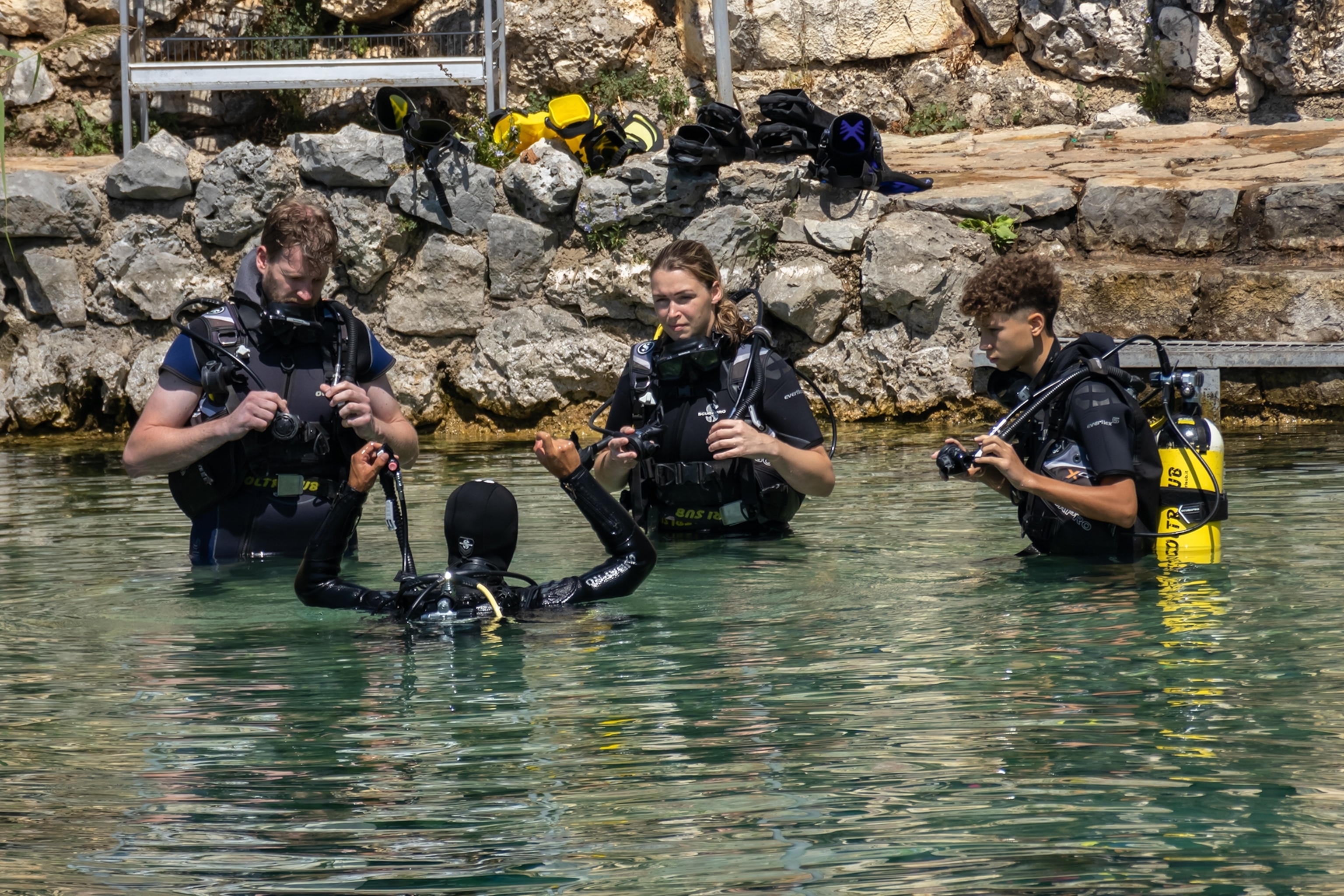Scuba divers on the surface of lake.