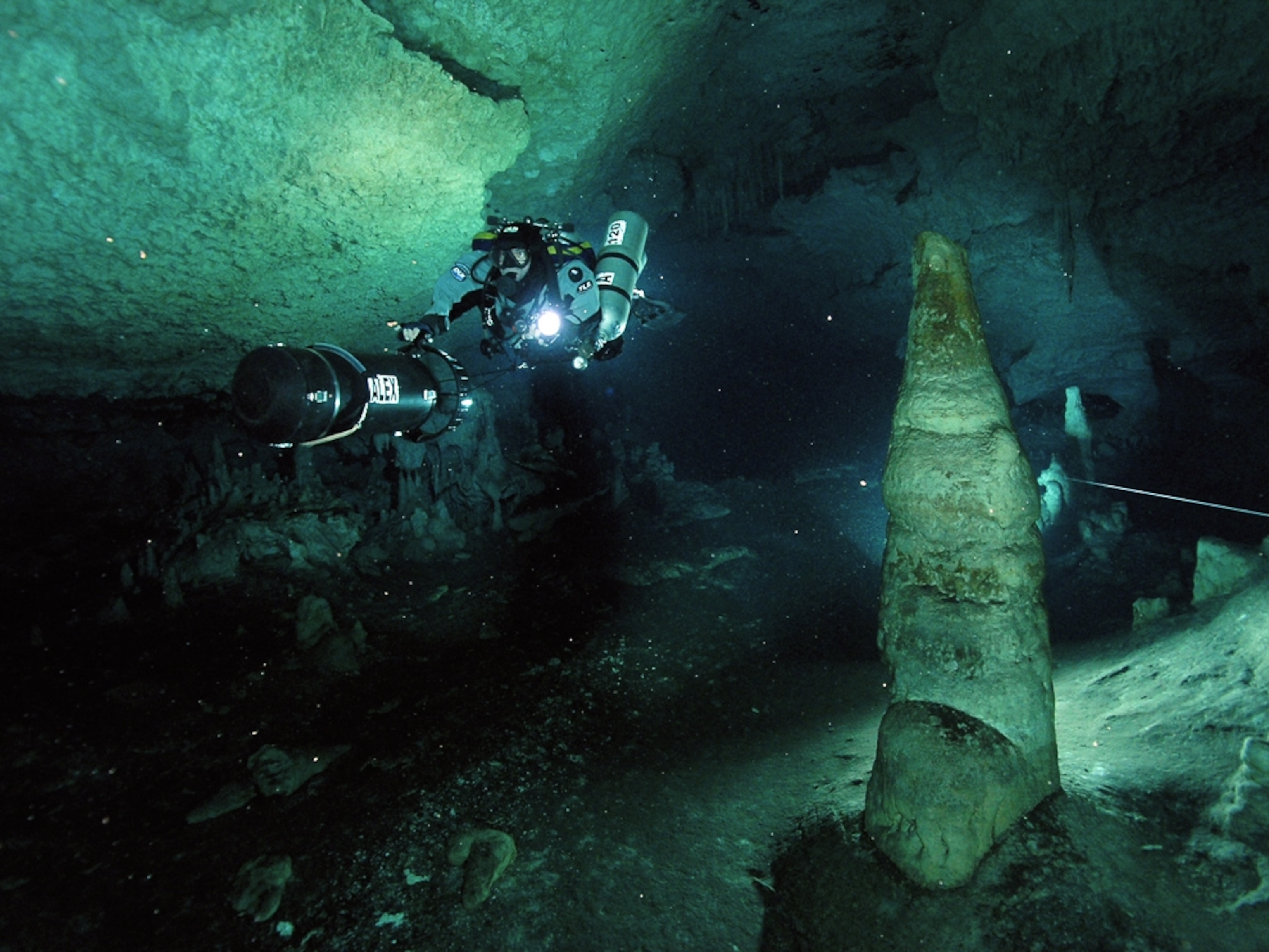 Mexican underwater cave (picture): Divers explore Hoyo Negro cave on scooters.