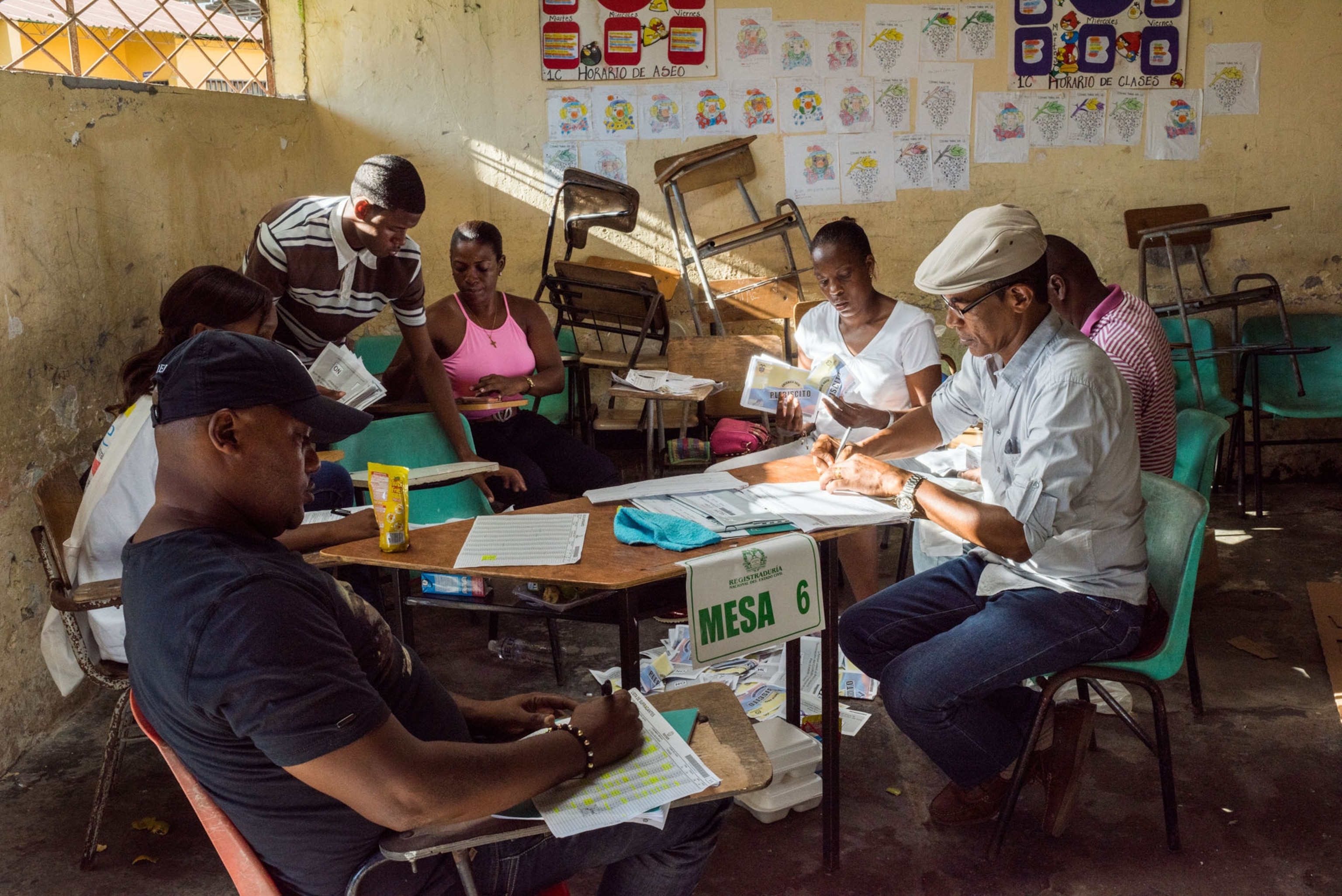 public employees checking votes in a classroom