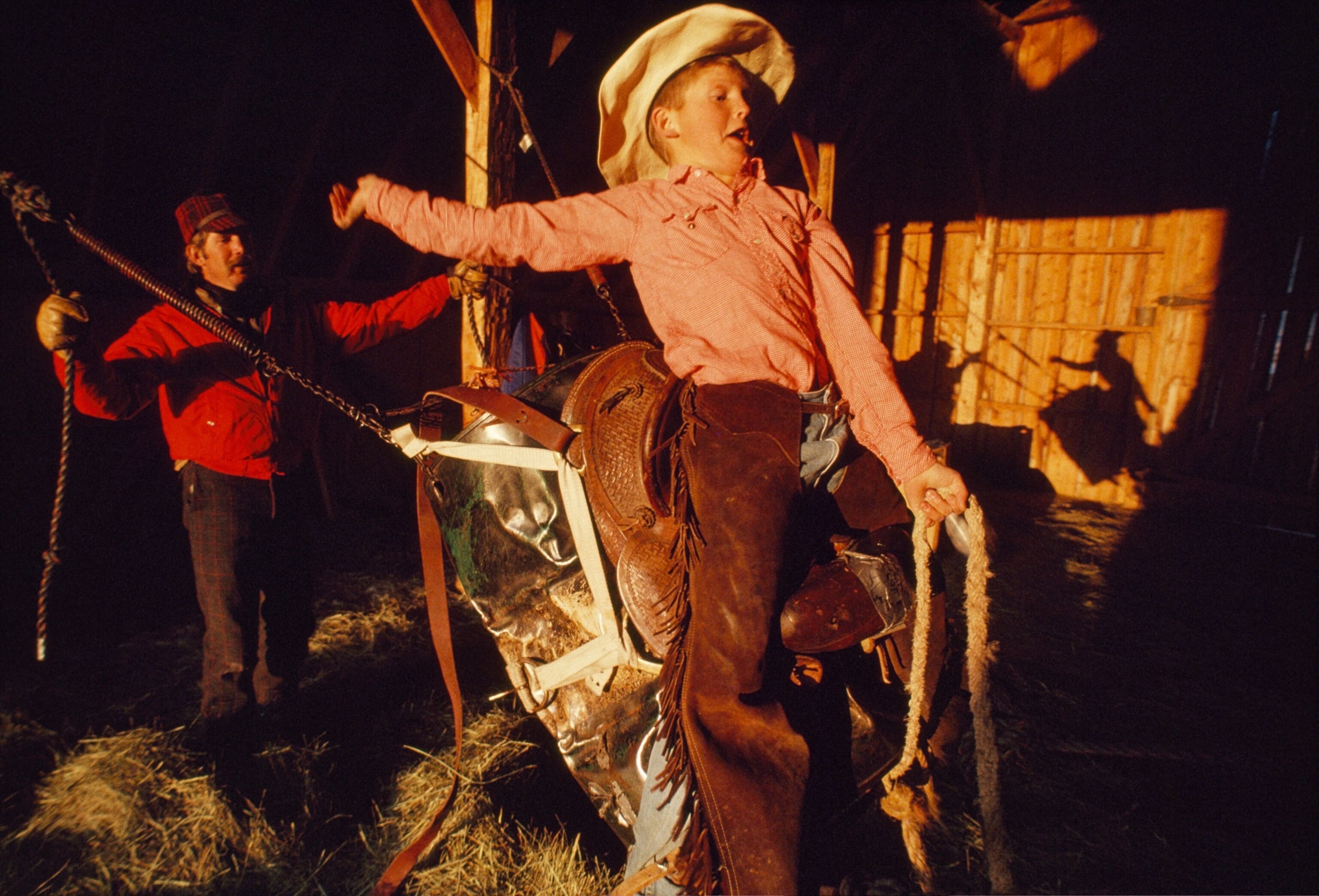 a young cowboy riding a barrel