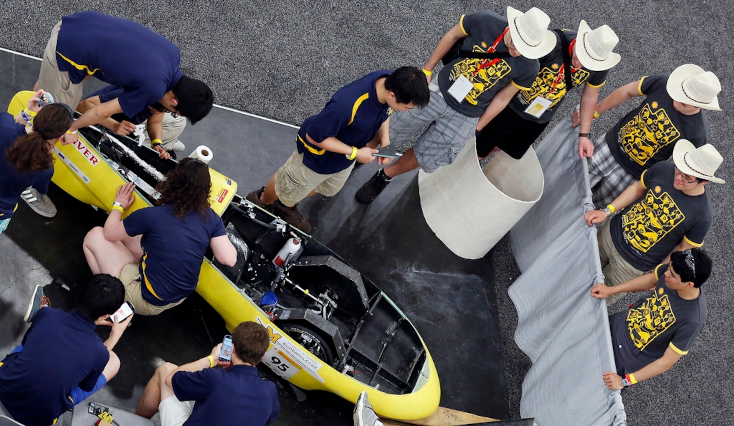 The University of Michigan UM Supermileage team makes last-minute adjustments to their Cypress II gas-powered prototype in their workstation Saturday at the George R. Brown Convention Center in Houston. Photo courtesy of Shell Eco-marathon.
