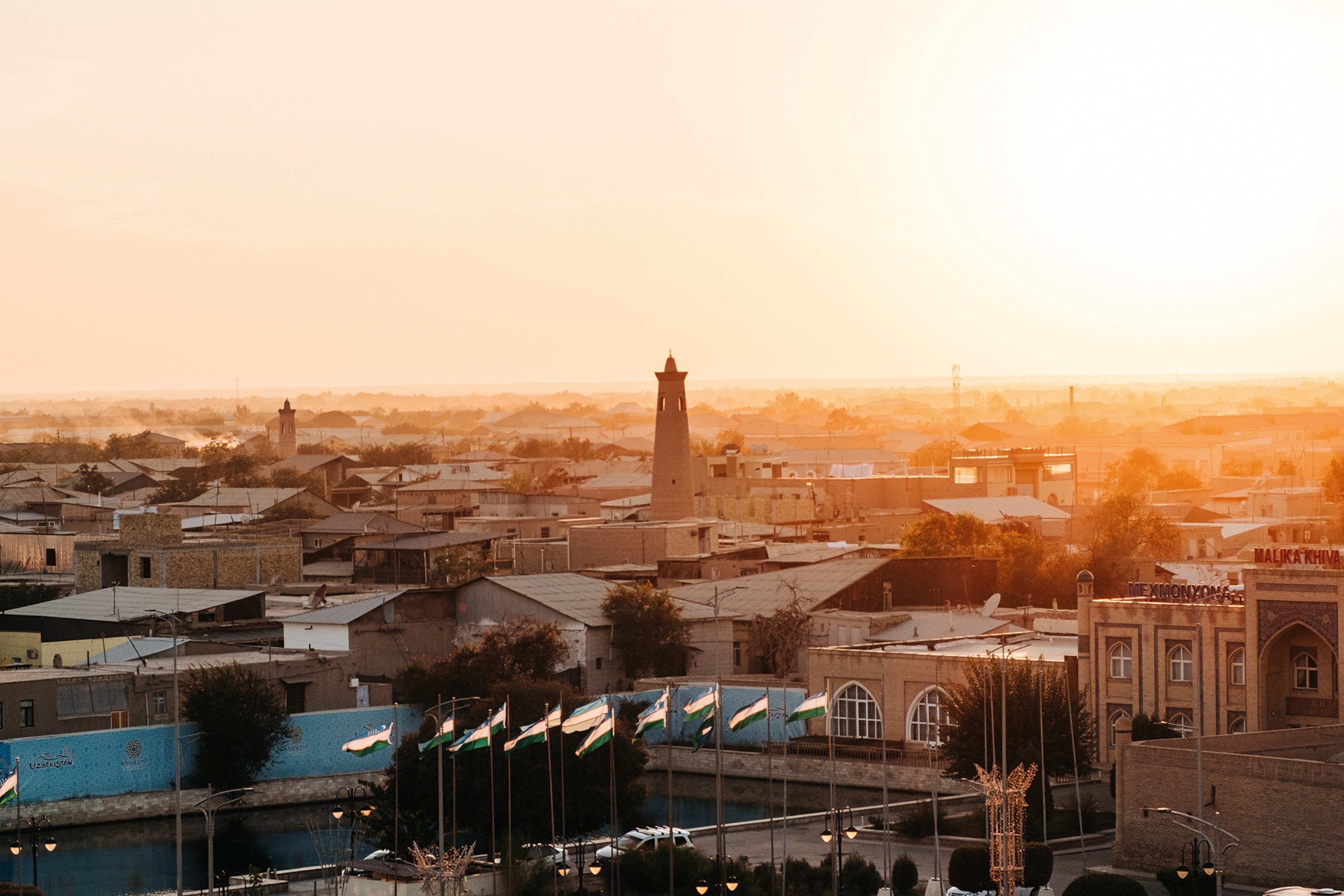 A mystical aerial shot of a flat-roofed, medieval city in the morning glow.