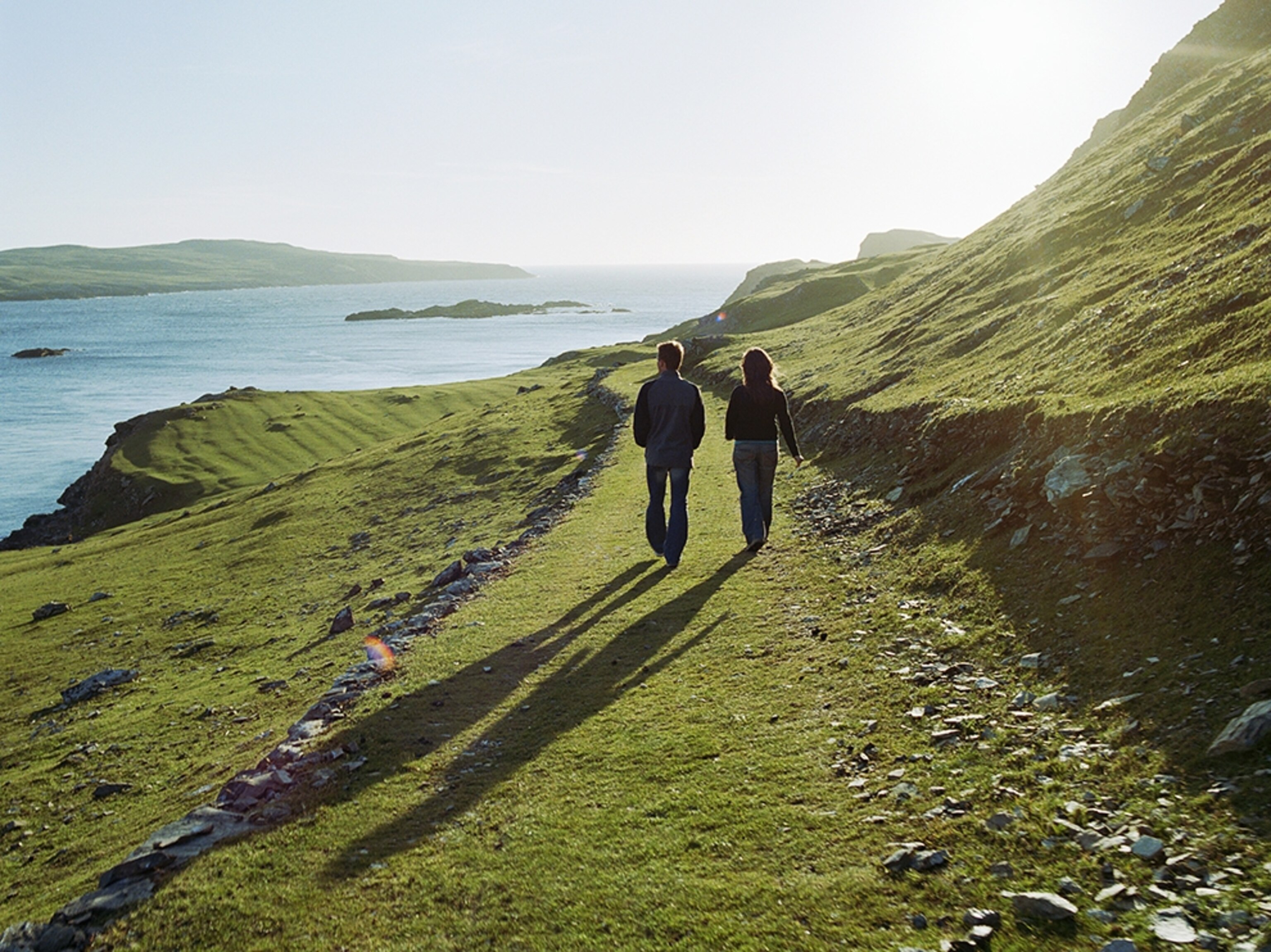 couple walking by sea, Inishbofin, Connemara, Ireland