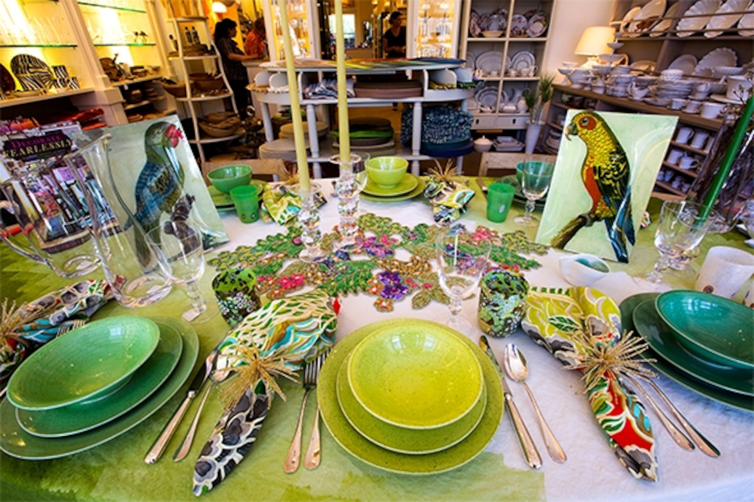 At Sue Fisher King, a favorite shop for elegant home decor in San Francisco's tony Presidio Heights neighborhood, a table displays a beaded table runner, Murano "mille fiori" glasses, and John Derian decoupage parrot plates. (Photograph by Catherine Karnow)