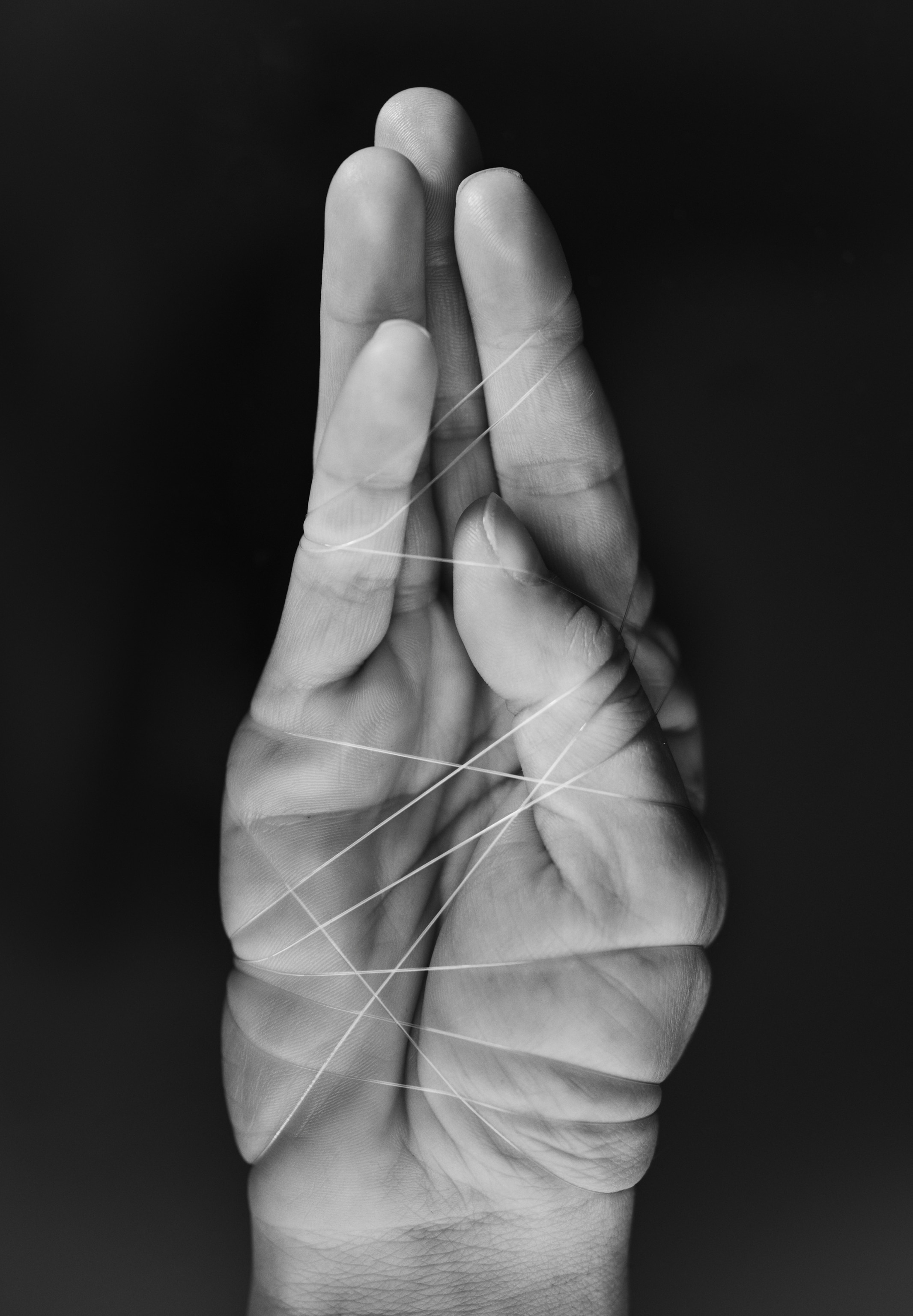 Human hand strangled with thread.