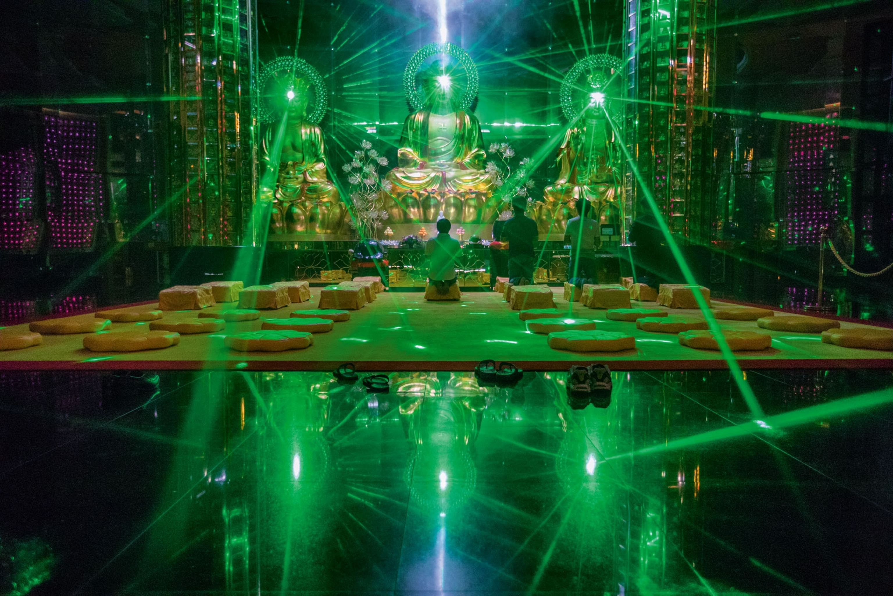 dramatic memorial ceremony in green laser lights in columbarium, Singapore