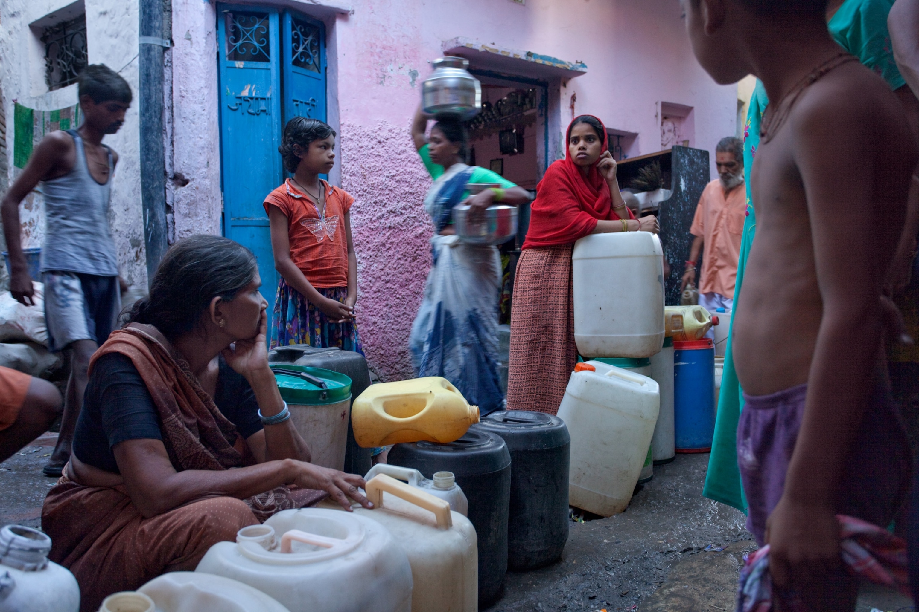Slum dwellers in Delhi waiting for a refill from a privately owned tap