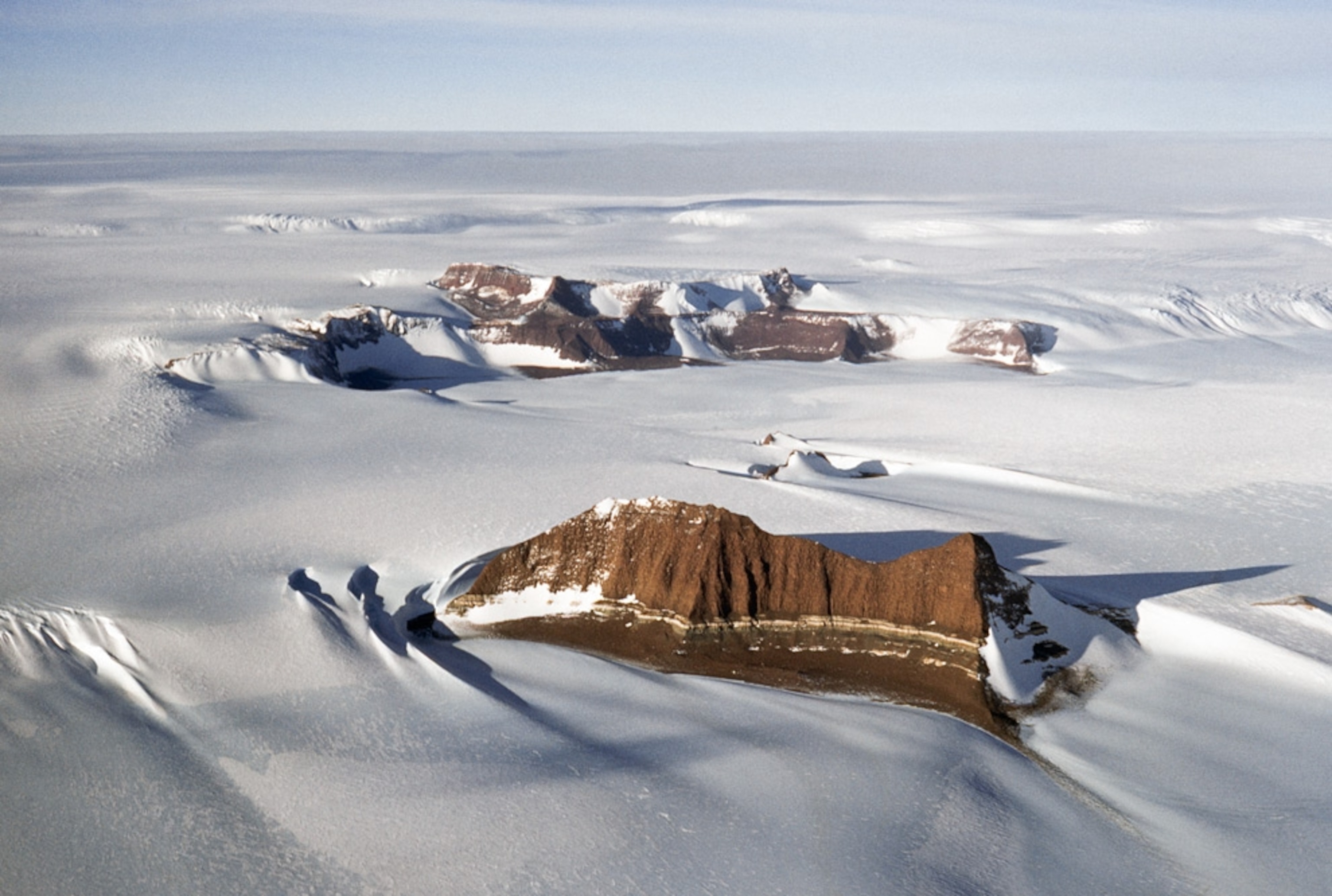 mountains extending above the ice sheet in Antarctica