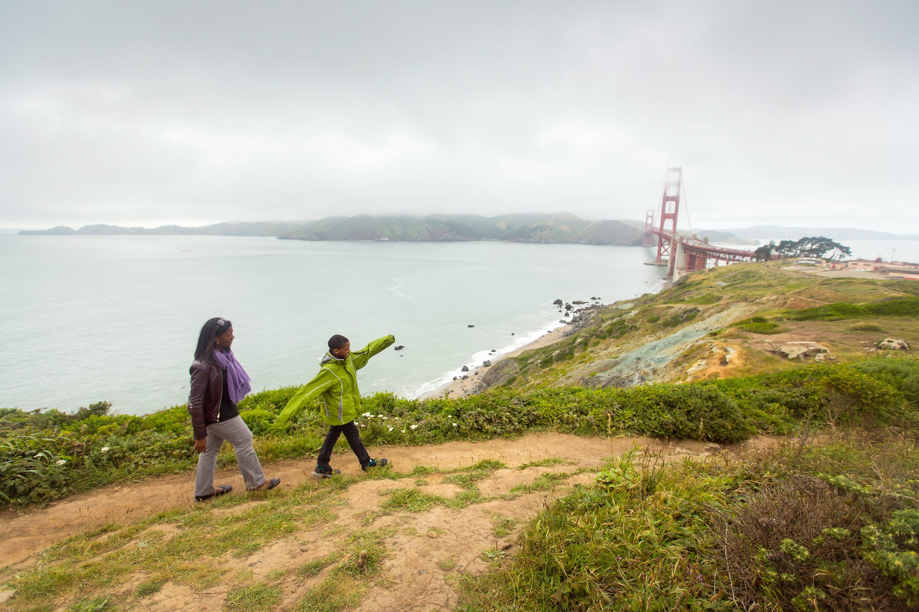 a family walking in fog near Golden Gate Bridge, San Francisco