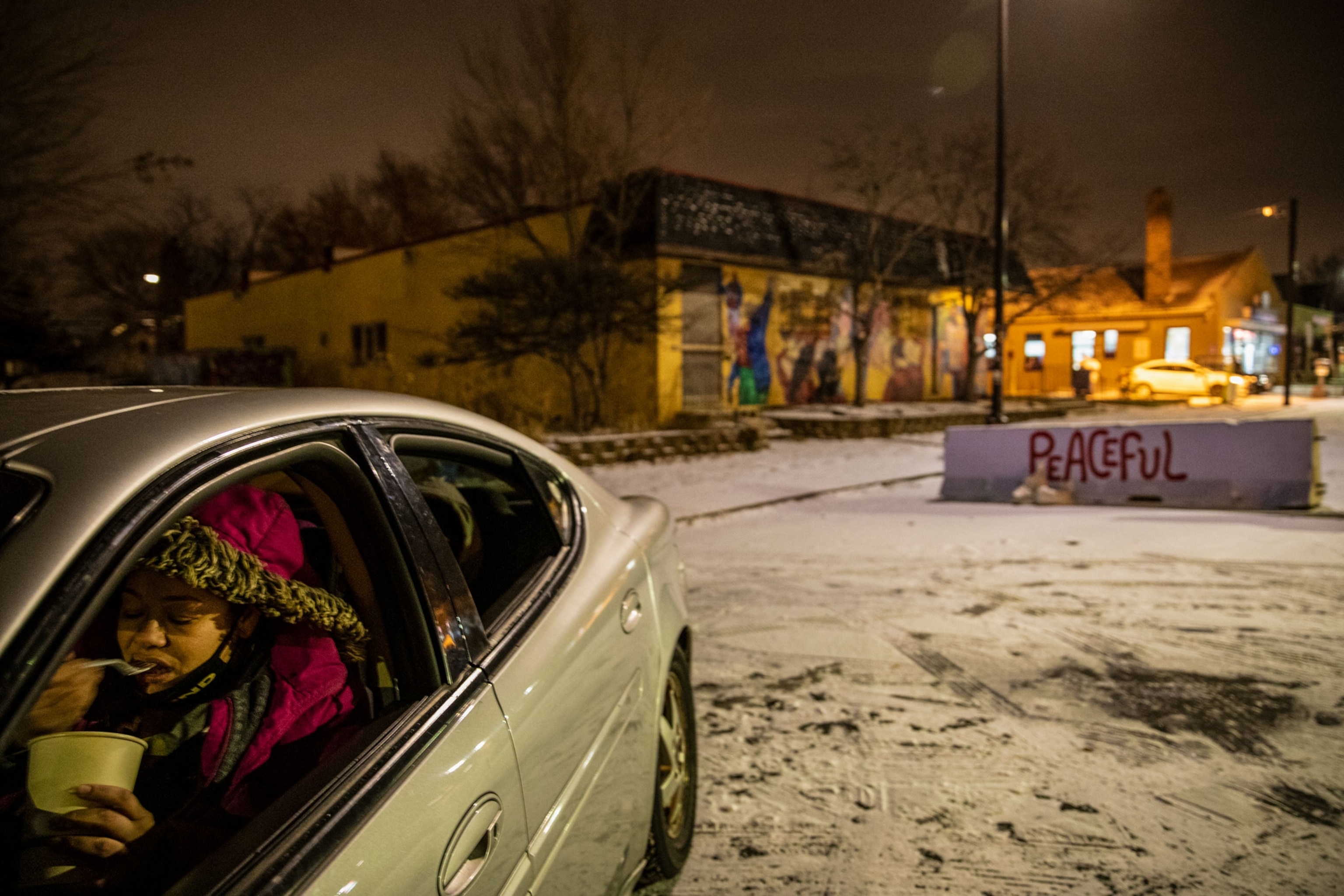 People in their car guard the entrance to George Floyd Square in Minneapolis, Minnesota.