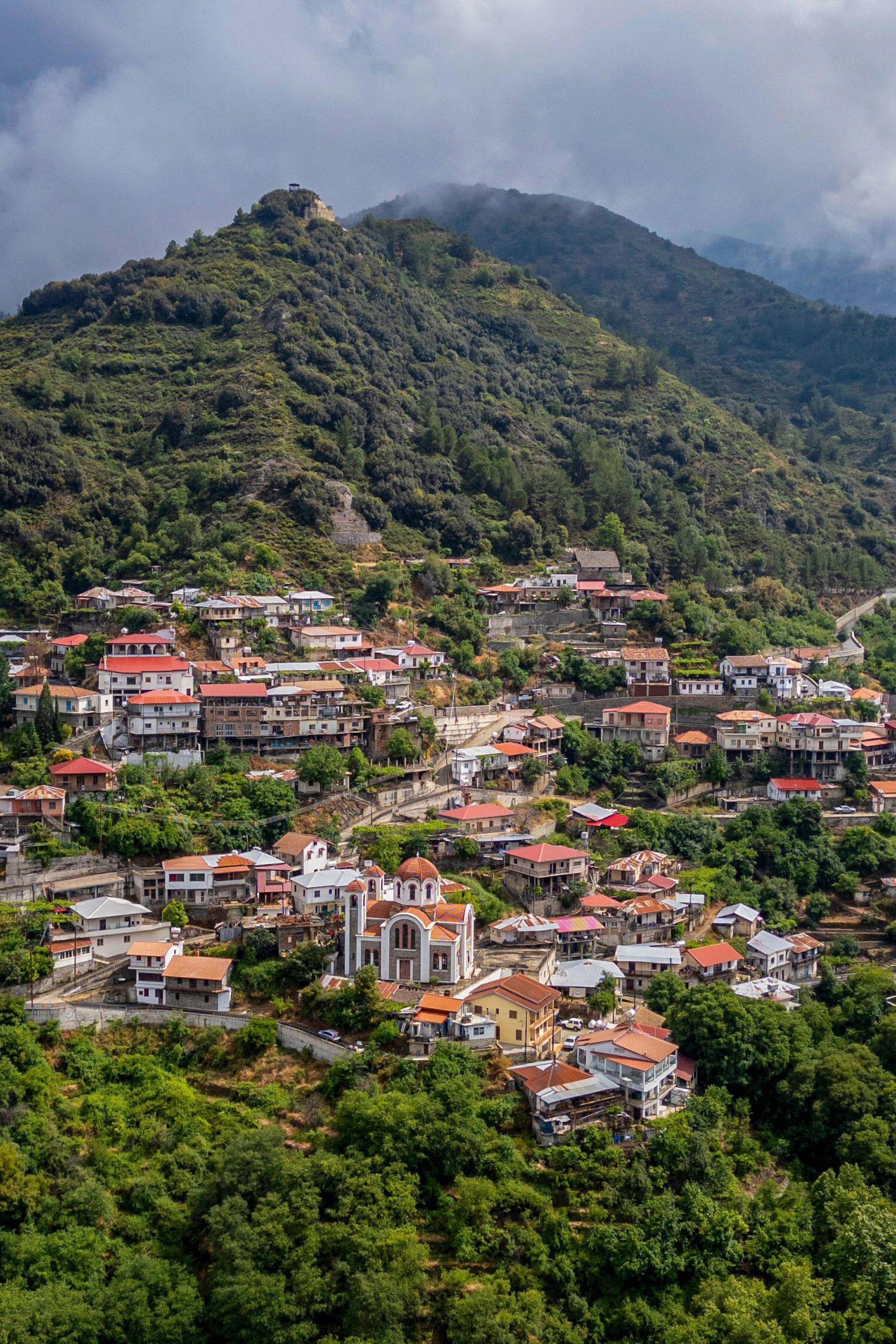 View from above of red-topped village in valley