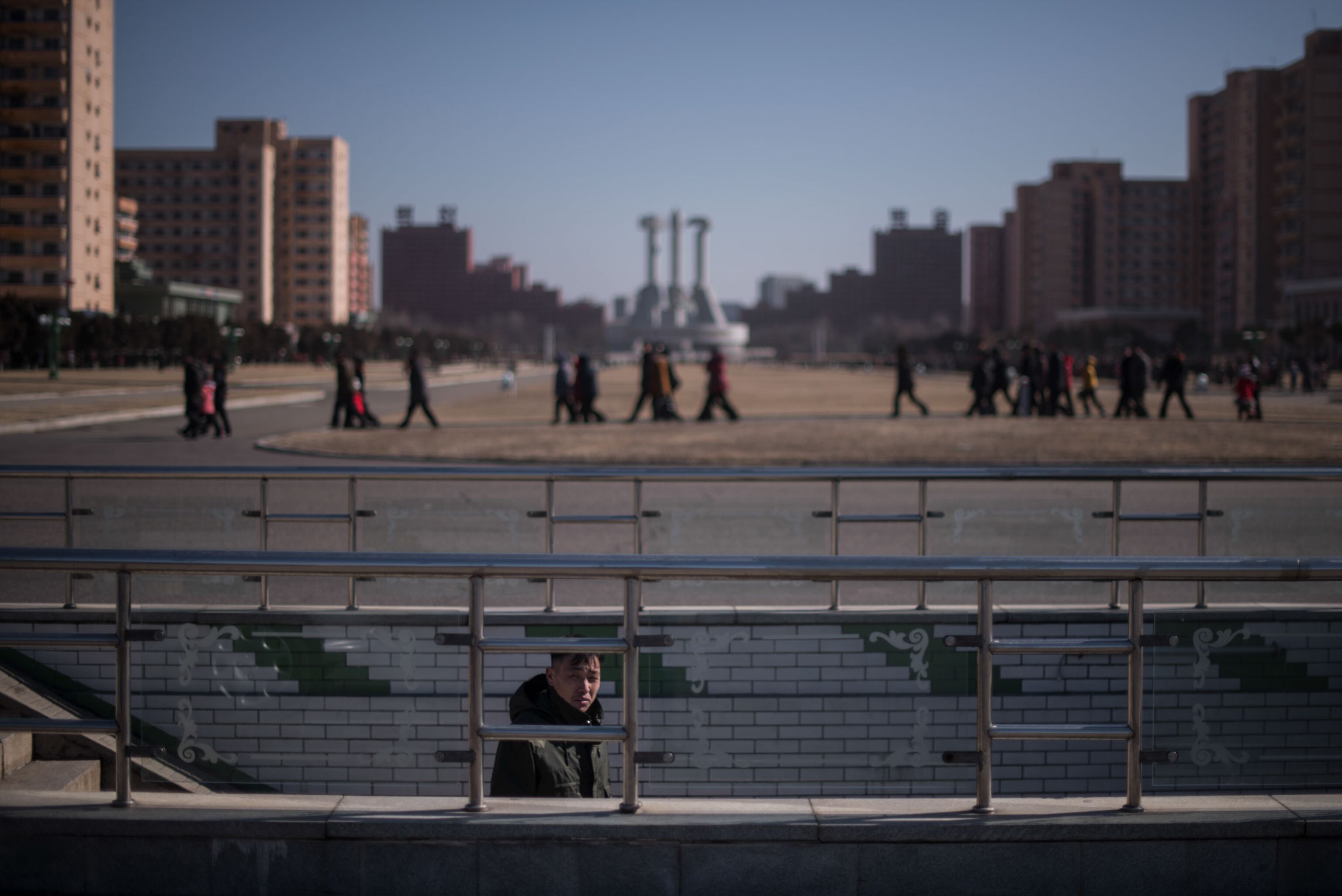 a man going down the stairs of an underpass