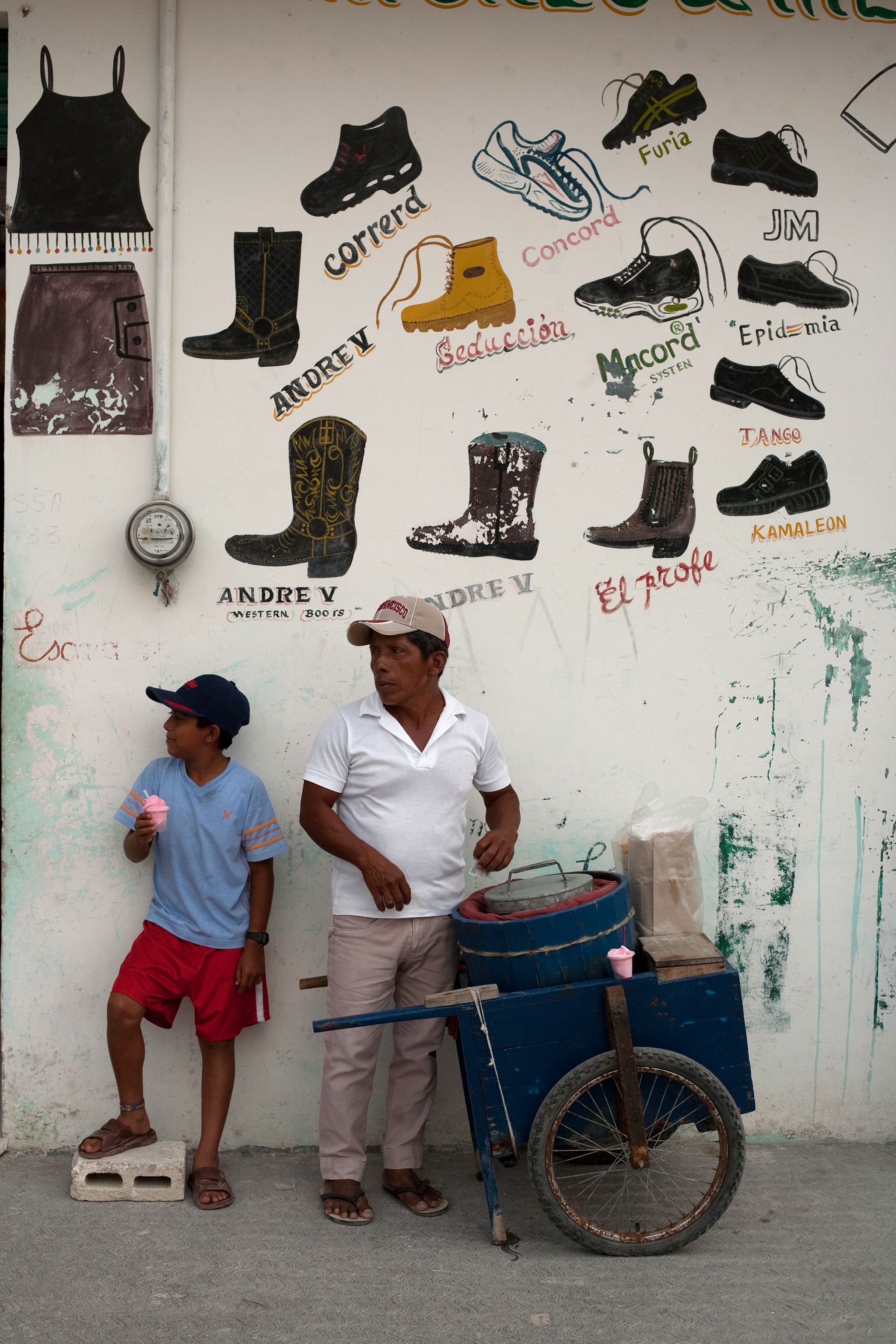 Juan Diaz Basque serves ice cream to Uzziel Marban on a hot day in Nicholas Bravo near Kohunlich and other Mayan Ruins.