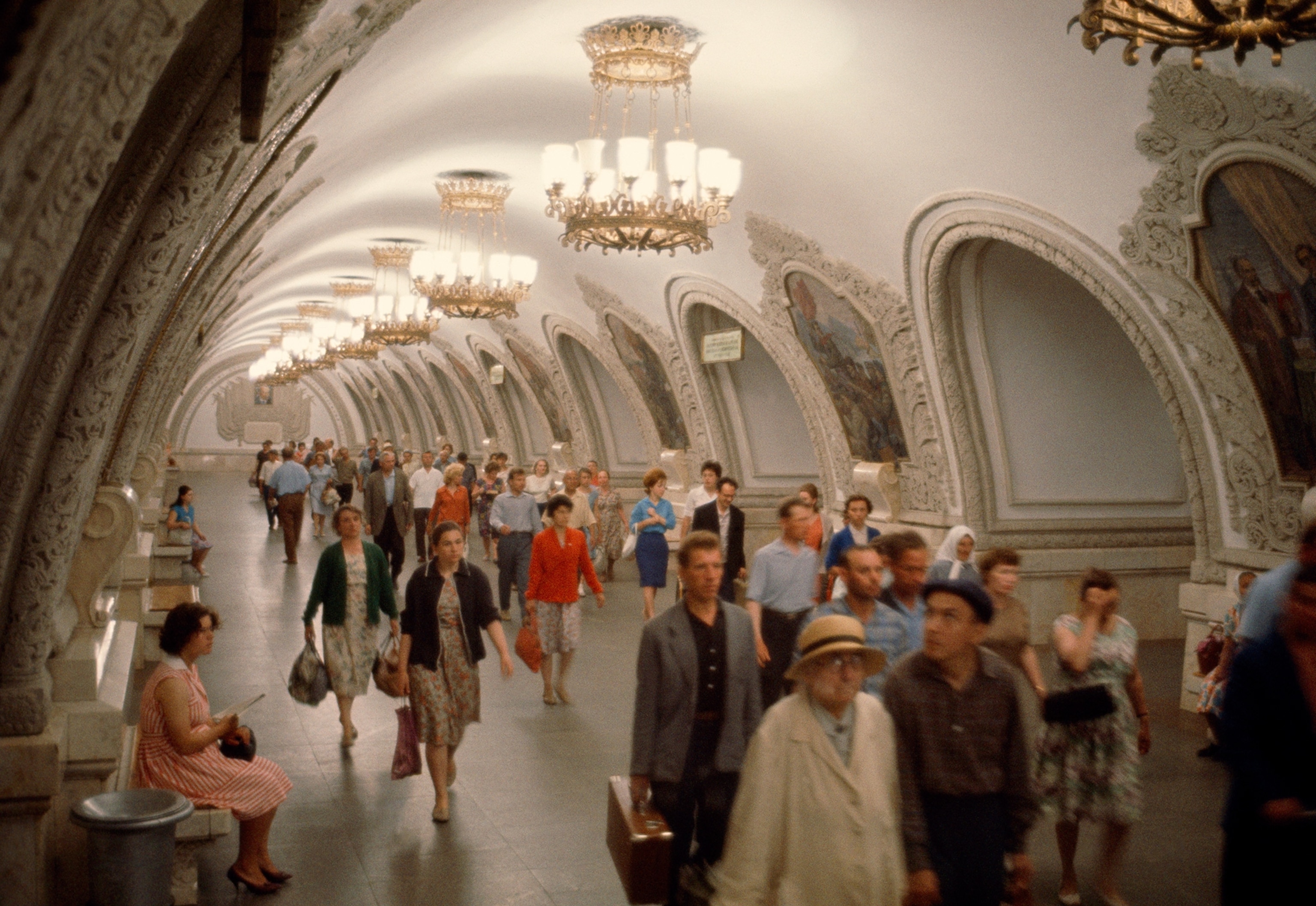 people walking down a corridor in the Moscow Metro