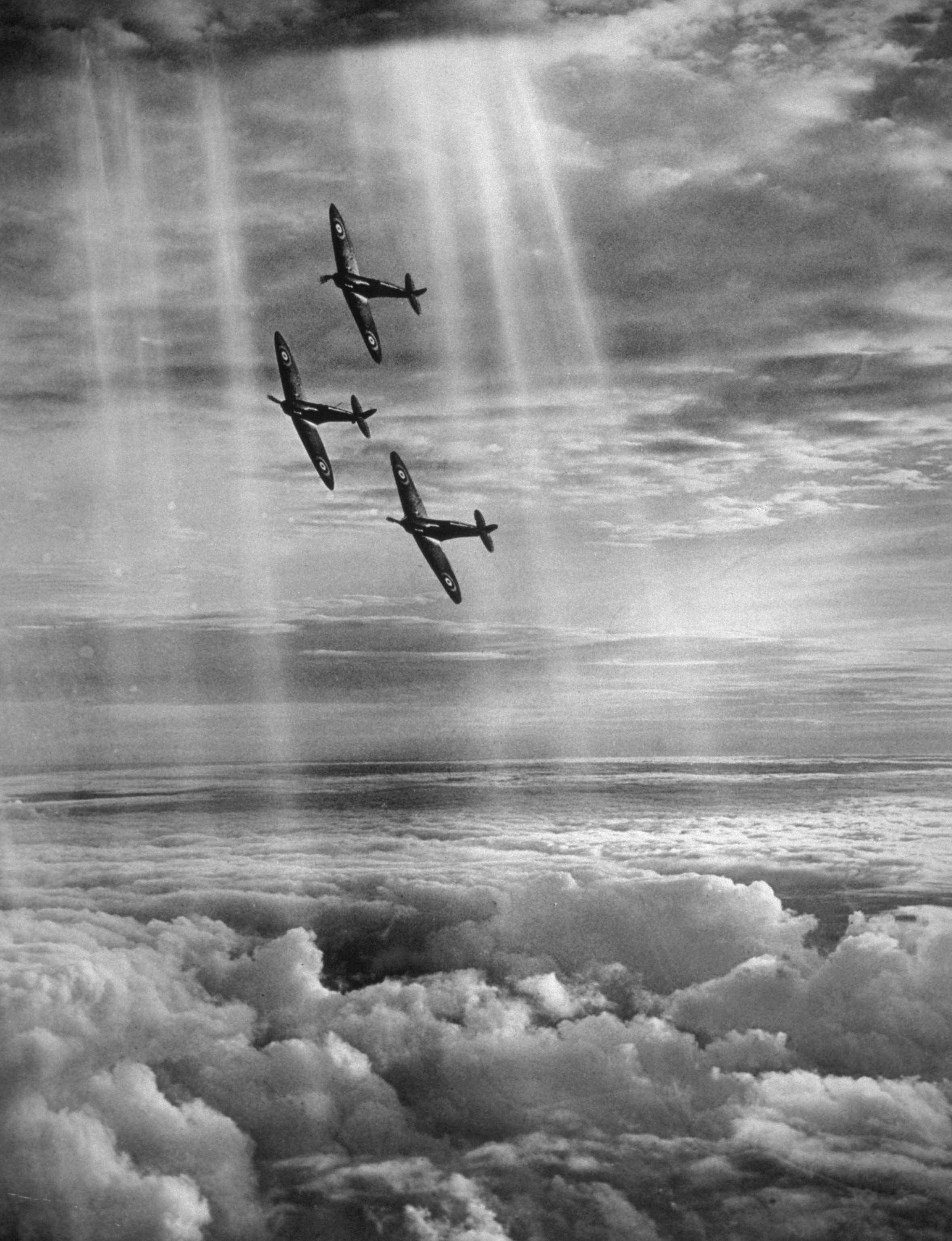 British Spitfire fighters flying in formation through the rays of the sun above the clouds, 16th February 1939.