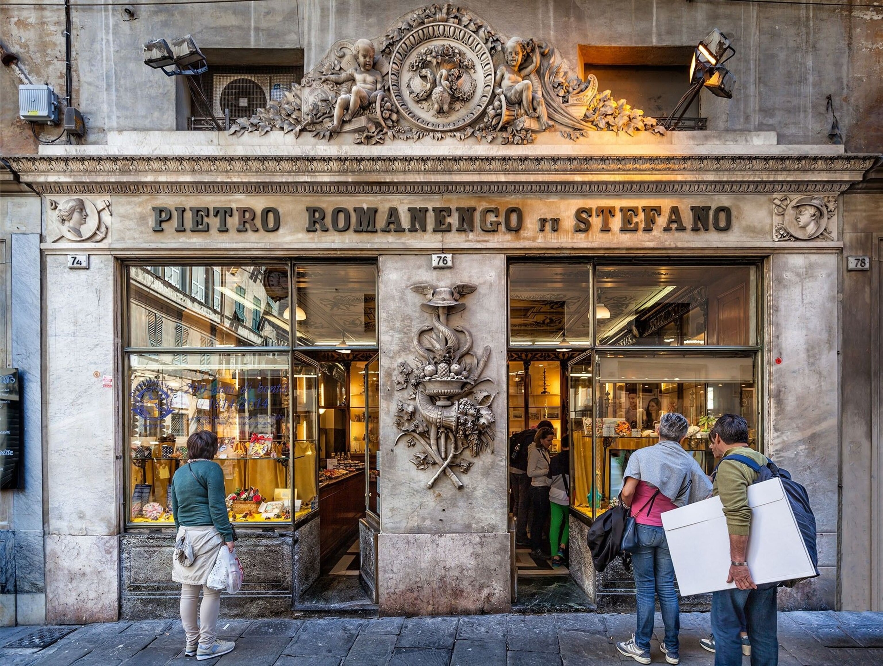 Passers-by outside Romanengo fu Stefano.