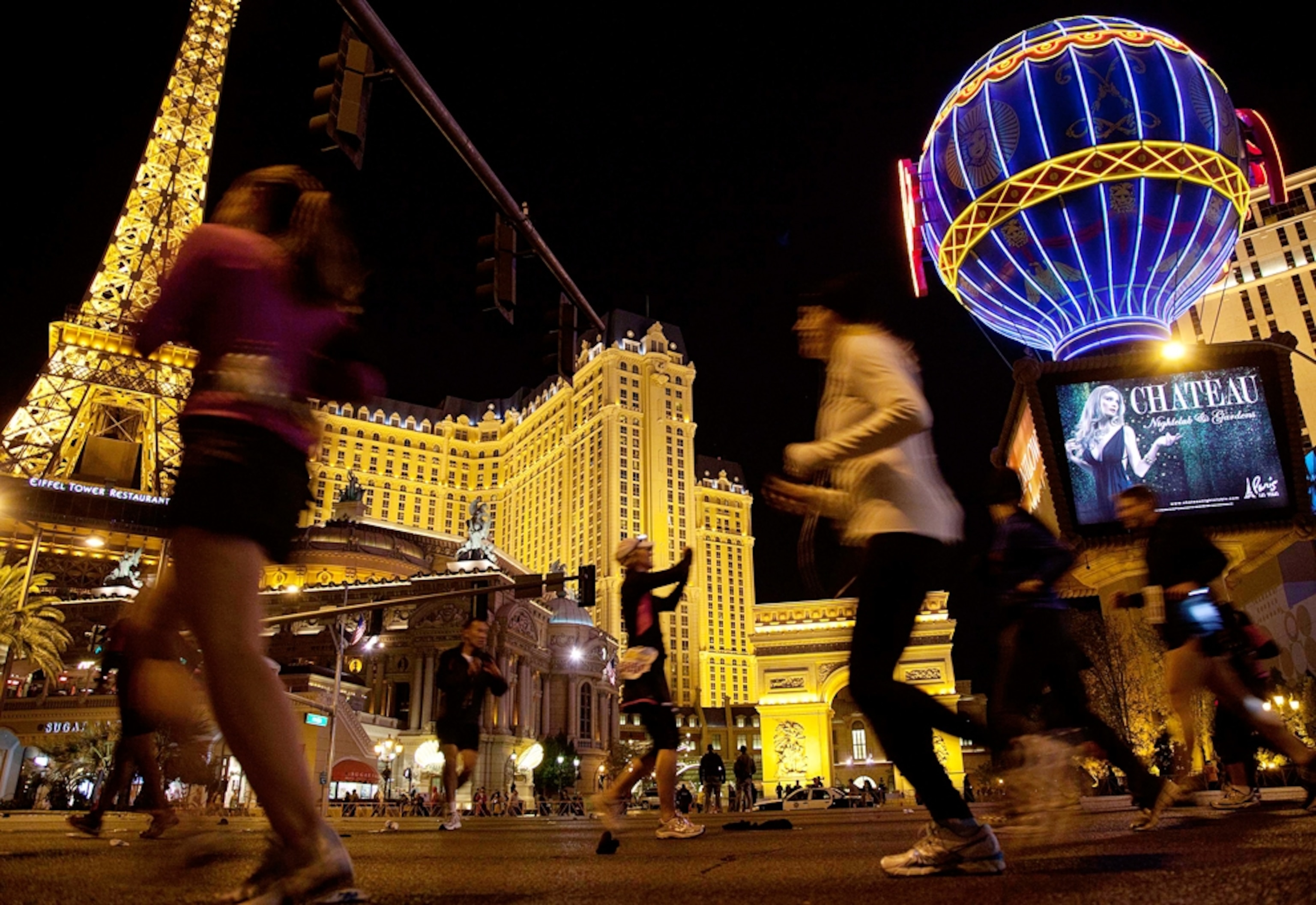 Runners head northward past the Paris Hotel and Casino on Las Vegas Boulevard during the Rock n Roll Las Vegas Marathon, Sunday, Dec. 4, 2011, in Las Vegas.
