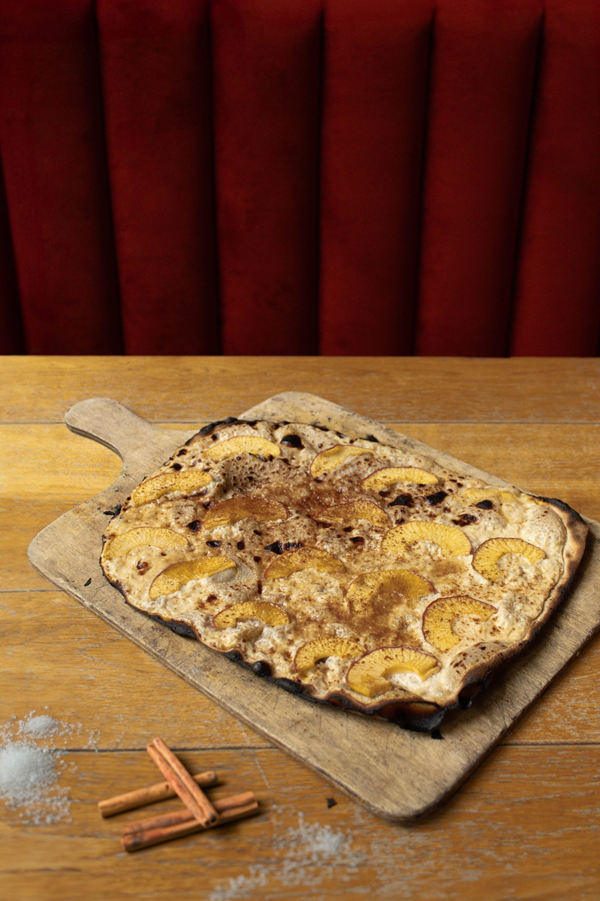 A thin, square pie with apple and cinnamon topping.